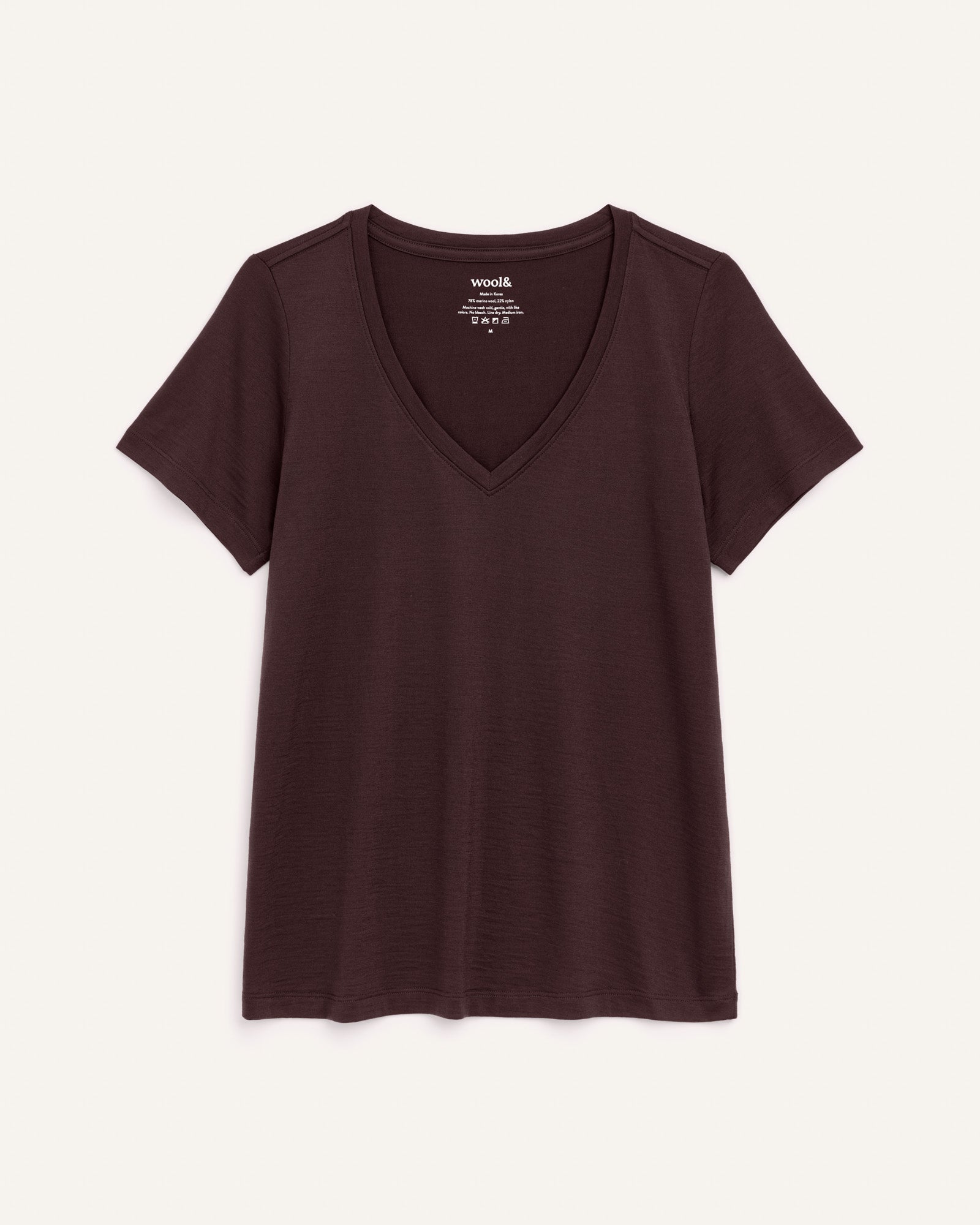 Laydown of Morgan V-Neck Tee in Espresso, a warm dark brown color. Morgan V-Neck Tee is a merino wool short sleeve, v-neck, regular fit tee available in sizes XS-3X.