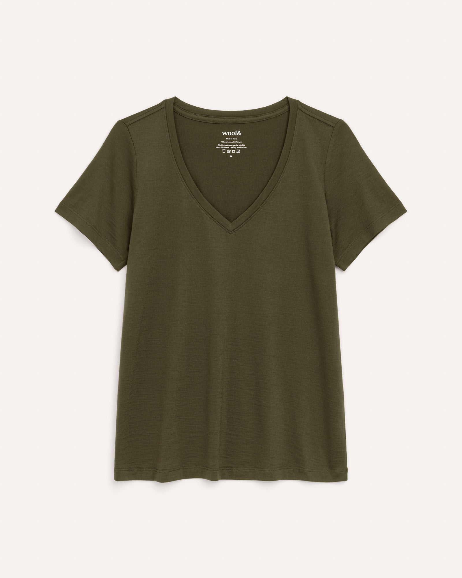 Laydown of Morgan V-Neck Tee in Forest Night, a muted dark green color. Morgan V-Neck Tee is a merino wool short sleeve, v-neck, regular fit tee available in sizes XS-3X.