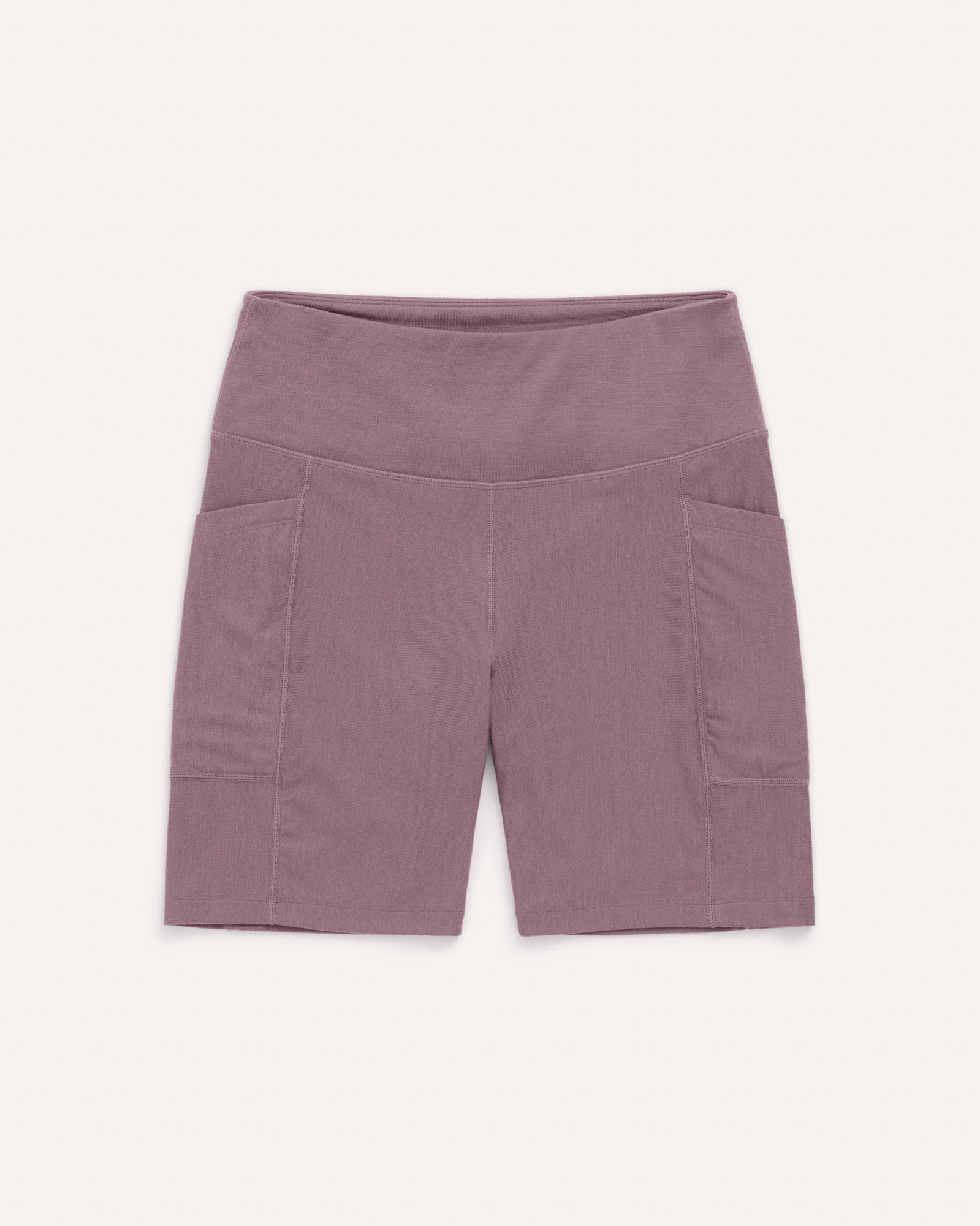 Laydown of Summit Pocket Bike Short in Lavender, a dusky muted purple color. Summit Pocket Bike Short is a merino wool short with pockets available in sizes XS-3X.