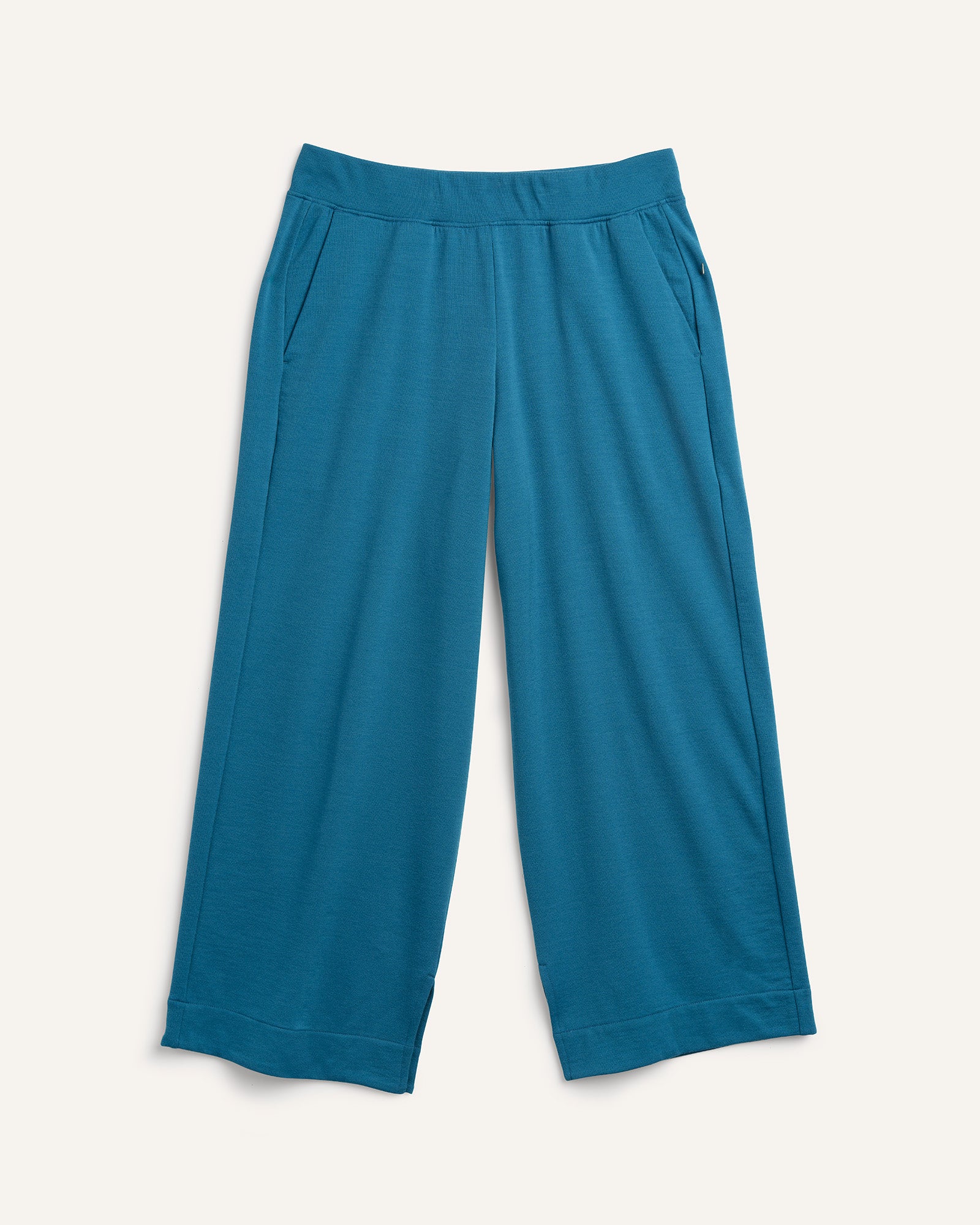 Laydown of Aspen Wide Leg Crop Sweatpants in Ocean Teal, a medium blue-green color. Aspen Wide Leg Crop Sweatpants is a merino wool sweatpant with pockets available in sizes XS-3X.