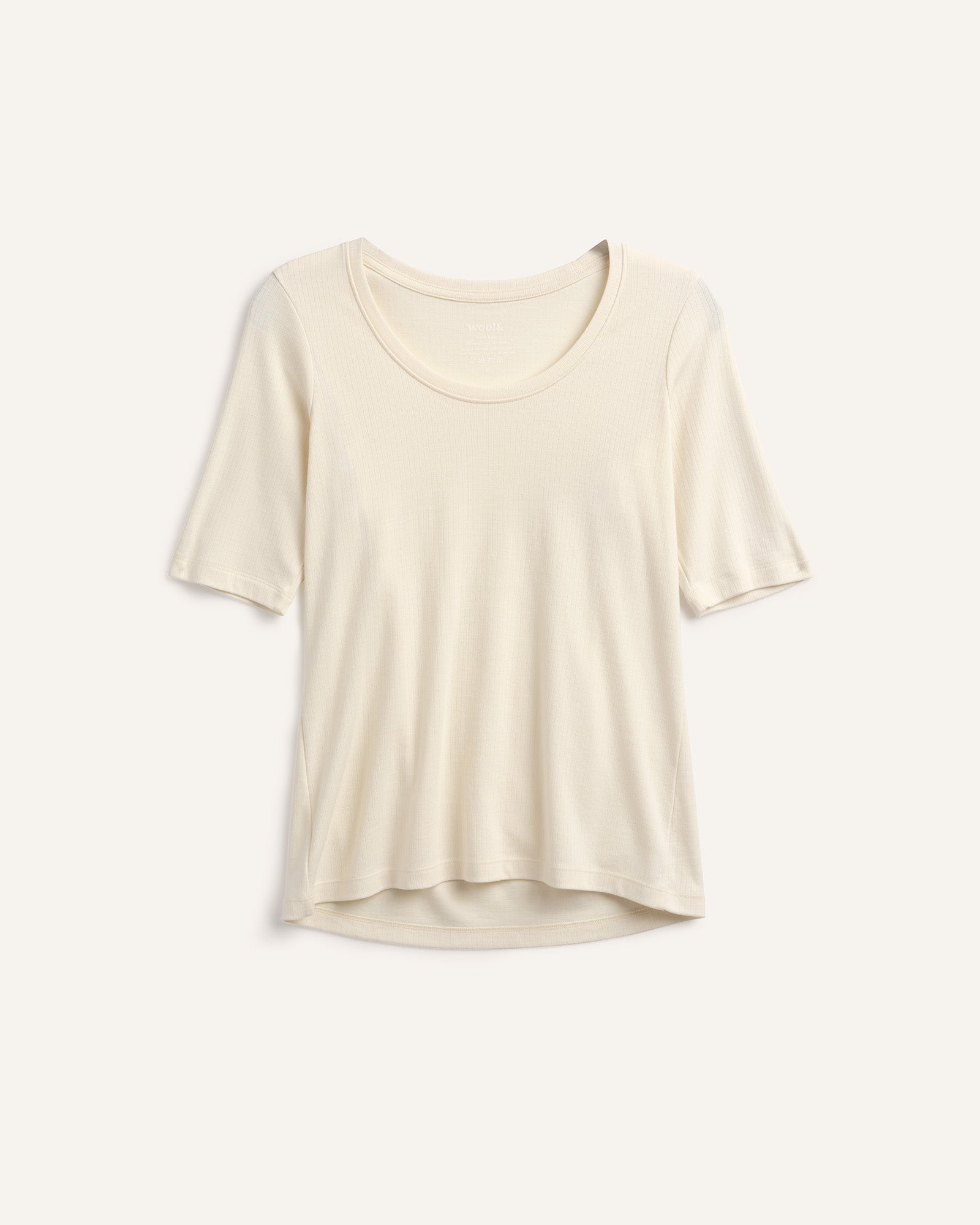 Laydown of Celine Ribbed Elbow Sleeve Tee in Natural White, an off-white cream color. Celine Ribbed Elbow Sleeve Tee is a merino wool short sleeve, scoop neck, slim fit tee available in sizes XS-3X.