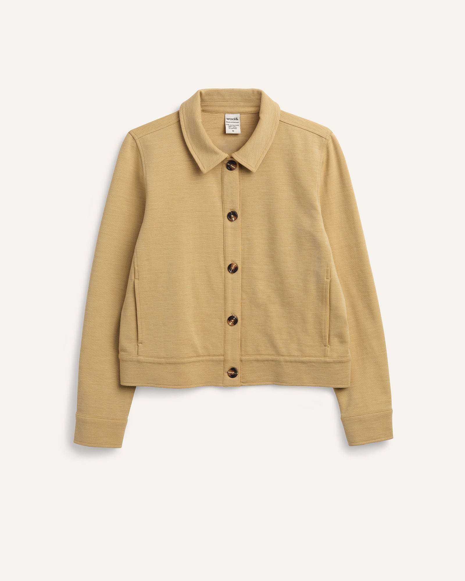 Laydown of Johnny Ponte Jacket in Sahara, a warm, sandy tan neutral color. Johnny Ponte Jacket is a merino wool long sleeve, collared, jacket with pockets available in sizes XS-XXL.