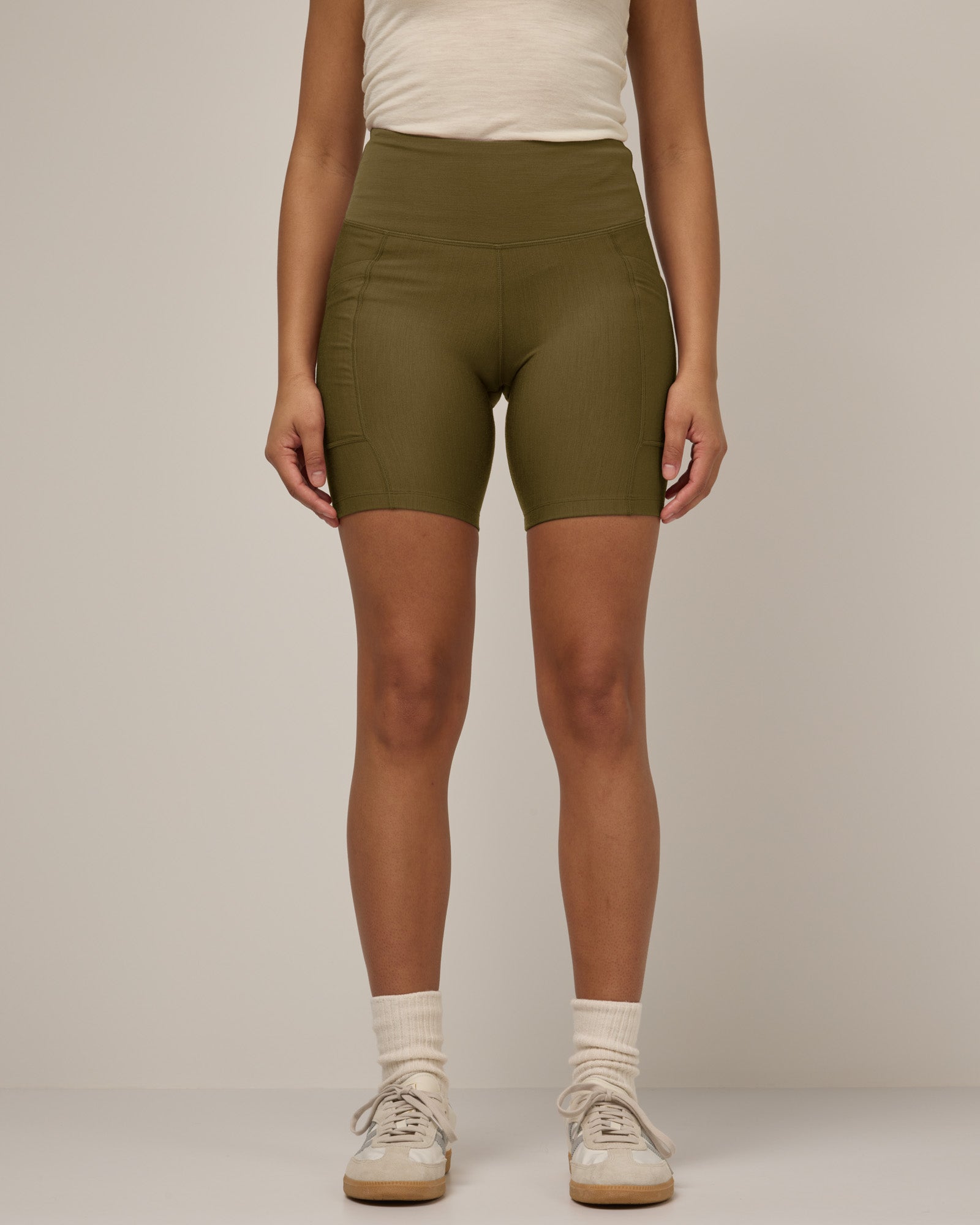 Model wearing Summit Pocket Bike Short in Olive. Summit Pocket Bike Short is a merino wool short with pockets available in sizes XS-3X.