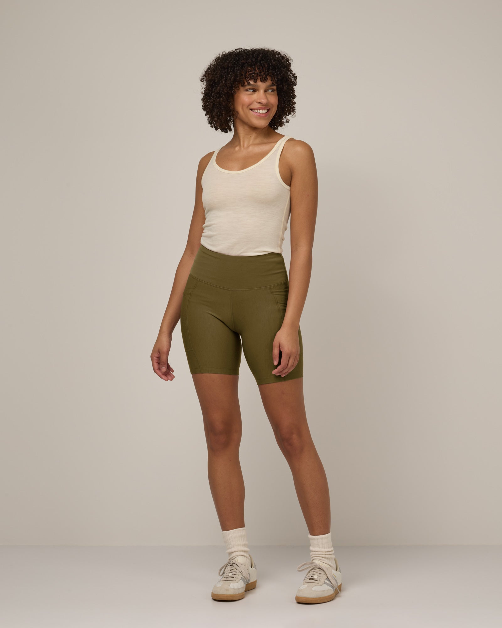 Model wearing Summit Pocket Bike Short in Olive. Summit Pocket Bike Short is a merino wool short with pockets available in sizes XS-3X.