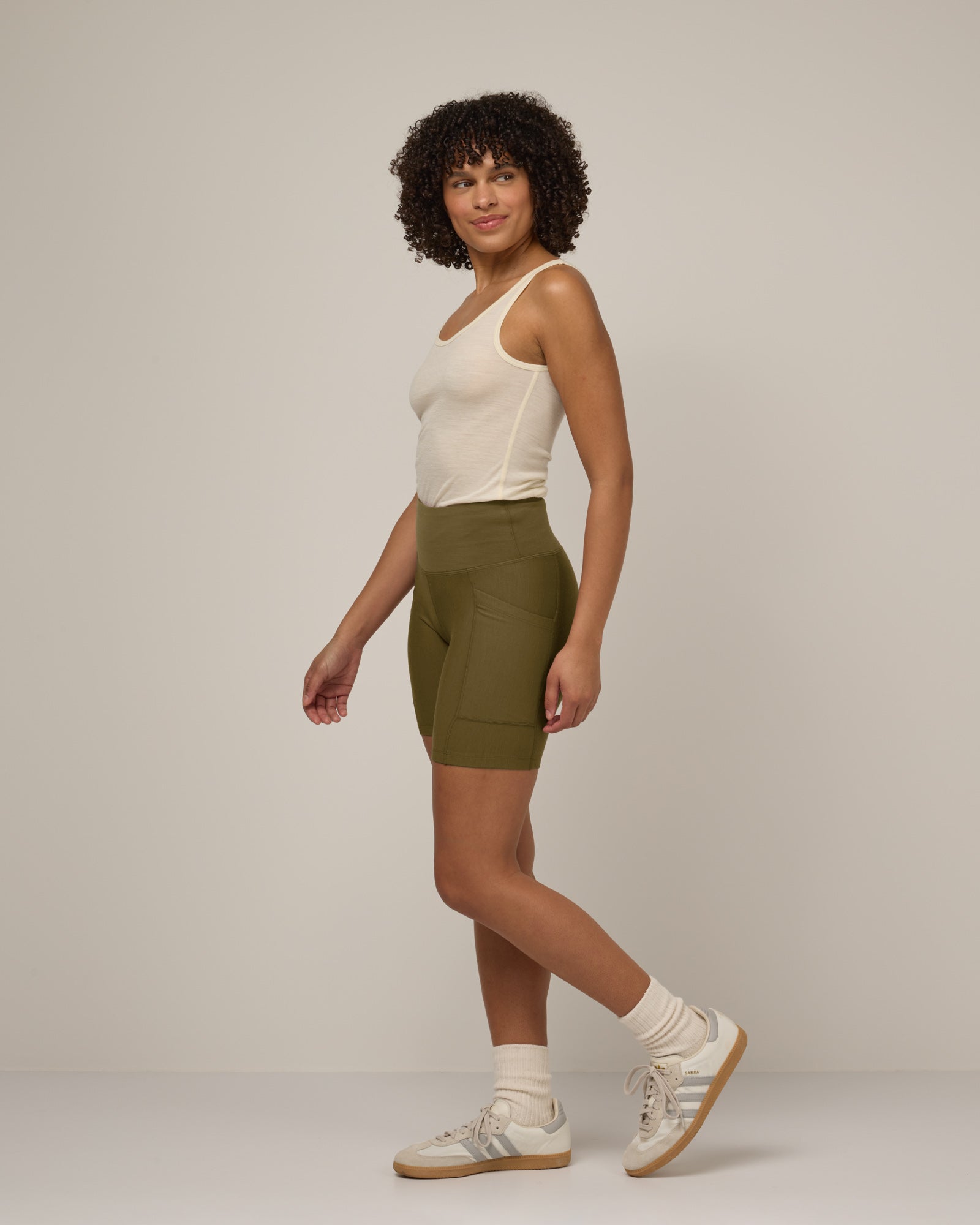 Model wearing Summit Pocket Bike Short in Olive. Summit Pocket Bike Short is a merino wool short with pockets available in sizes XS-3X.