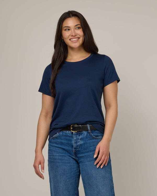 Model wearing Zoe Easy Crew Neck Tee in Marine Blue, a deep royal blue color. Zoe Easy Crew Neck Tee is a merino wool short sleeve, crew neck, regular fit tee available in sizes XS-3X.