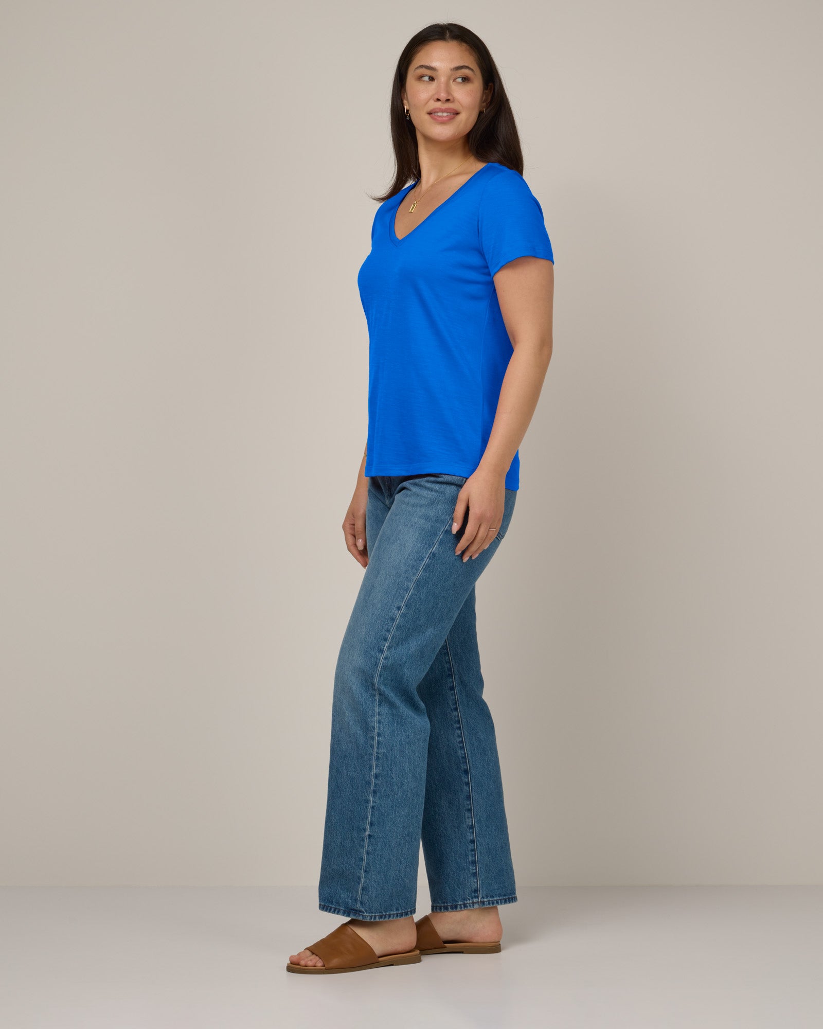 Model wearing Morgan V-Neck Tee in Ultramarine, a bright cobalt blue color. Morgan V-Neck Tee is a merino wool short sleeve, v-neck, regular fit tee available in sizes XS-3X.