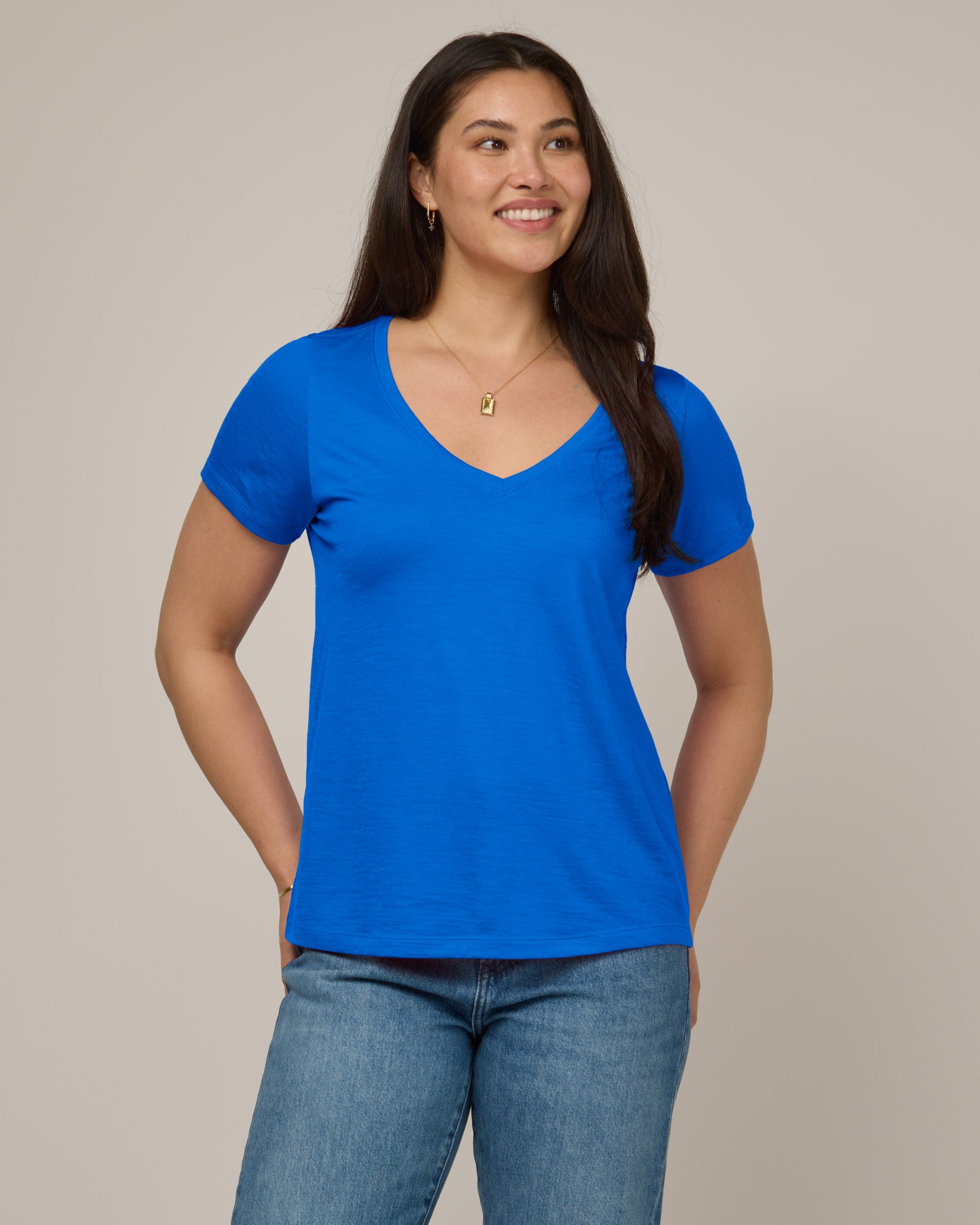 Model wearing Morgan V-Neck Tee in Ultramarine, a bright cobalt blue color. Morgan V-Neck Tee is a merino wool short sleeve, v-neck, regular fit tee available in sizes XS-3X.