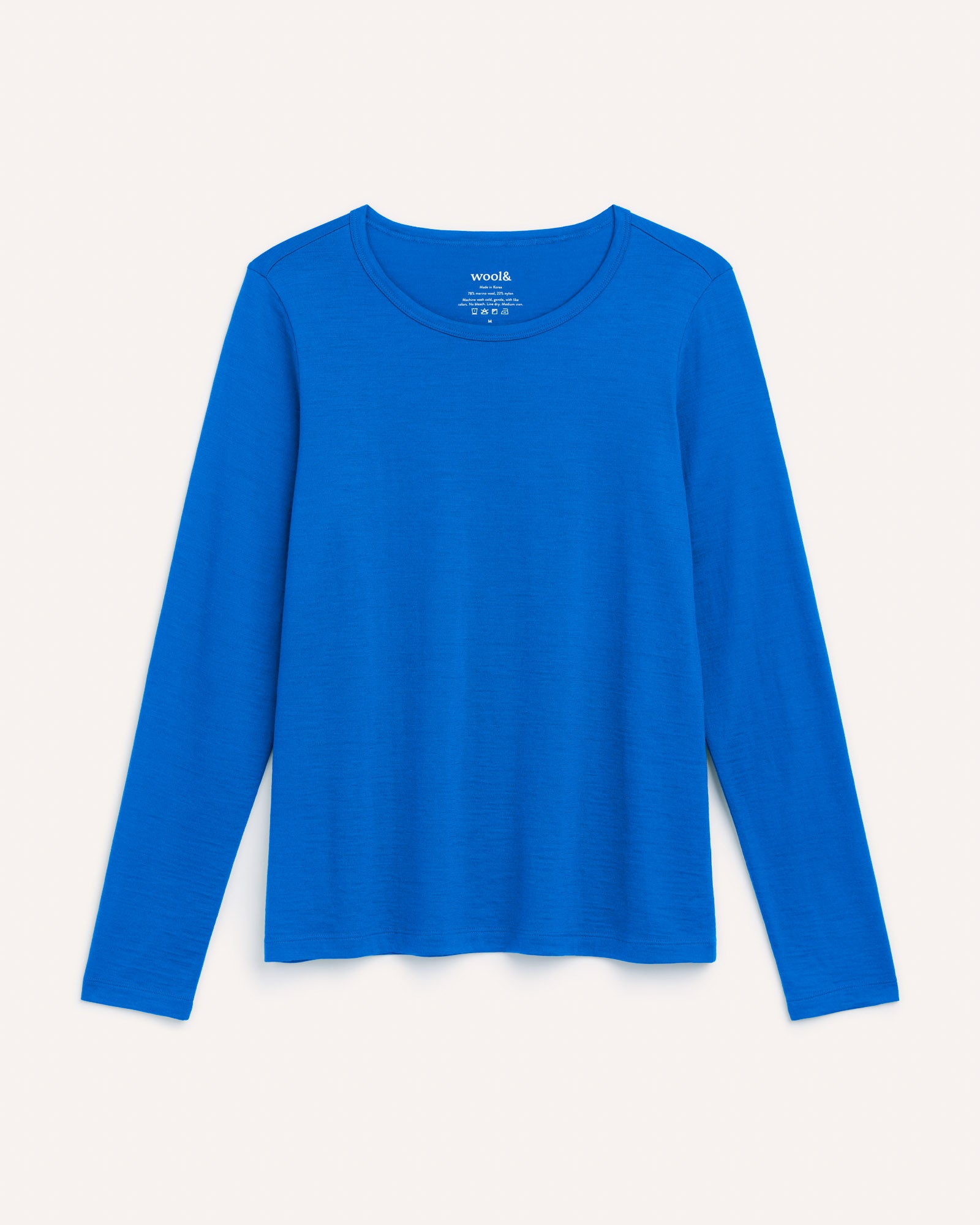 Laydown of Sloan Signature Fitted Tee in Ultramarine, a vibrant cobalt blue color. Sloan Signature Fitted Tee is a merino wool long sleeve, crew neck, slim fit tee available in sizes XS-3X.