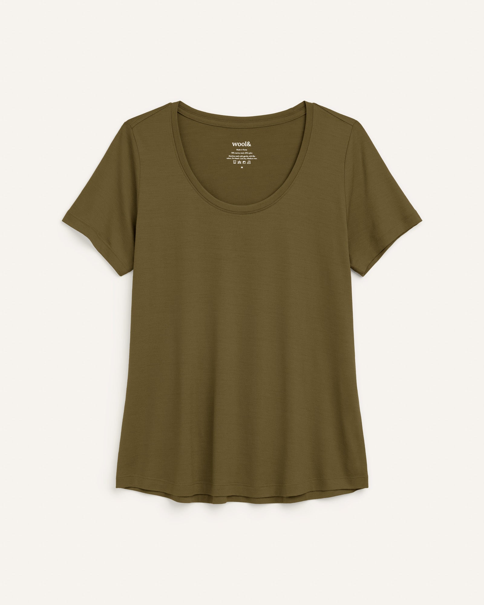 Laydown of Stella Signature Scoop Neck Tee in Olive. Stella Signature Scoop Neck Tee is a merino wool short sleeve, scoop neck, relaxed fit tee available in sizes XS-3X.