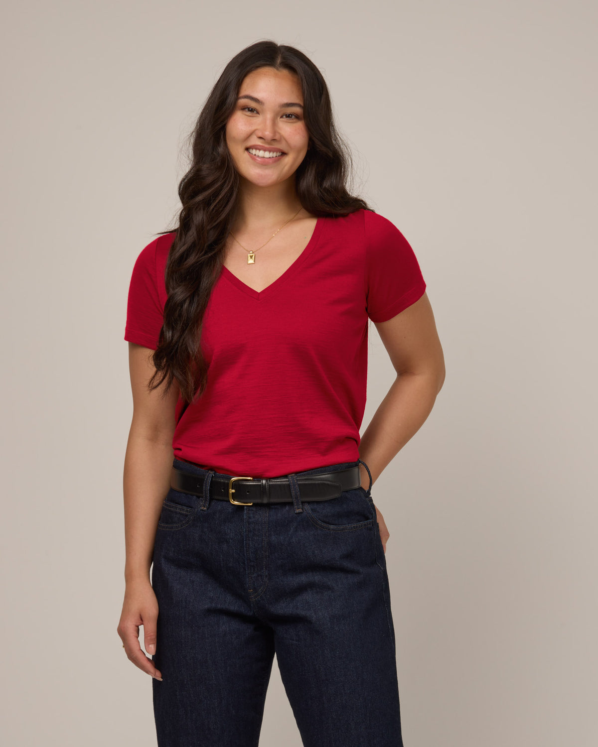 Model wearing Morgan V-Neck Tee in Cherry Red, a bright red color. Morgan V-Neck Tee is a merino wool short sleeve, v-neck, regular fit tee available in sizes XS-3X.