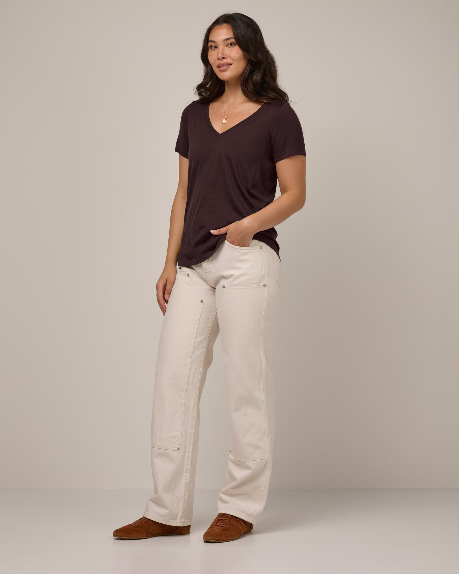Model wearing Morgan V-Neck Tee in Espresso, a warm dark brown color. Morgan V-Neck Tee is a merino wool short sleeve, v-neck, regular fit tee available in sizes XS-3X.