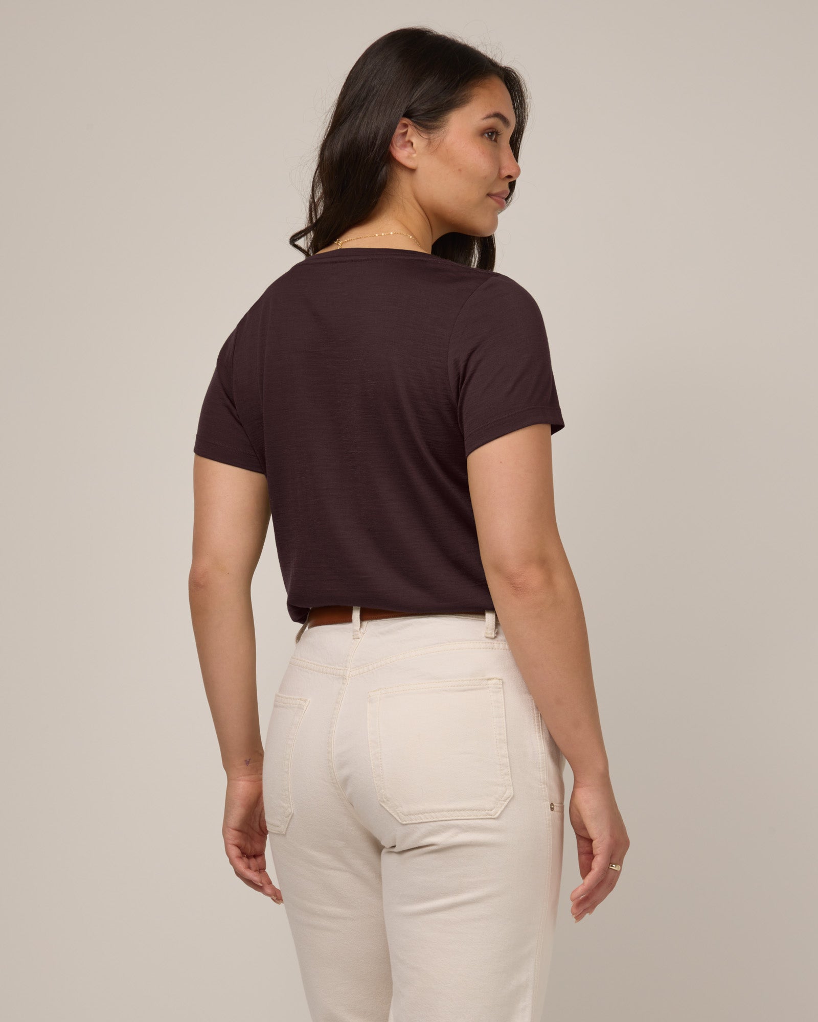 Model wearing Morgan V-Neck Tee in Espresso, a warm dark brown color. Morgan V-Neck Tee is a merino wool short sleeve, v-neck, regular fit tee available in sizes XS-3X.