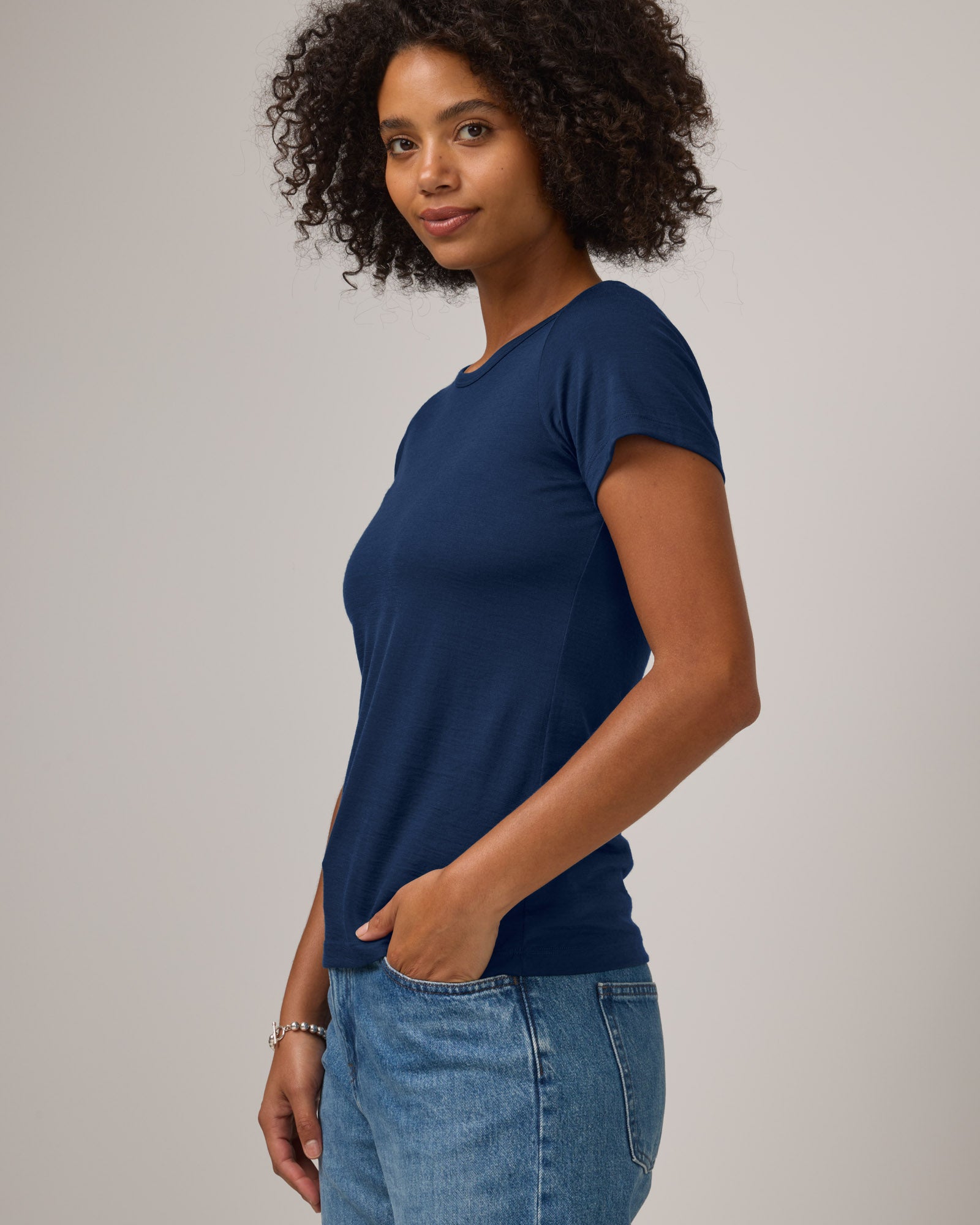 Model wearing Cara Signature Fitted Tee in Marine Blue, a dark royal blue color. Cara Signature Fitted Tee is a merino wool short sleeve, crew neck, slim fit tee available in sizes XS-3X.
