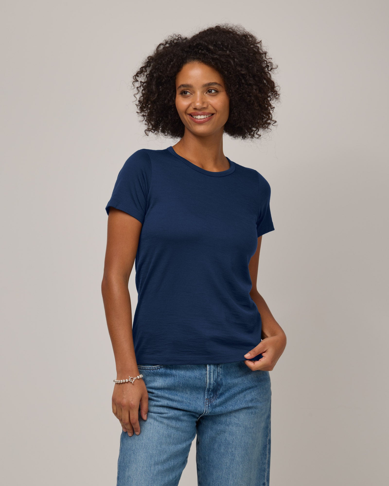Model wearing Cara Signature Fitted Tee in Marine Blue, a dark royal blue color. Cara Signature Fitted Tee is a merino wool short sleeve, crew neck, slim fit tee available in sizes XS-3X.
