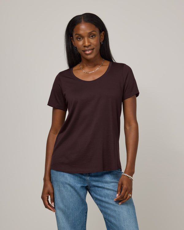 Model wearing Stella Signature Scoop Neck Tee in Espresso, a dark brown color. Stella Signature Scoop Neck Tee is a merino wool short sleeve, scoop neck, relaxed fit tee available in sizes XS-3X.