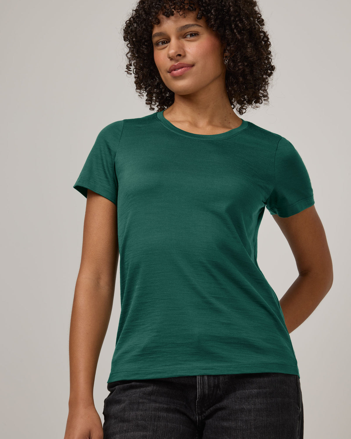 Model wearing Zoe Easy Crew Neck Tee in Emerald green. Zoe Easy Crew Neck Tee is a merino wool short sleeve, crew neck, regular fit tee available in sizes XS-3X.