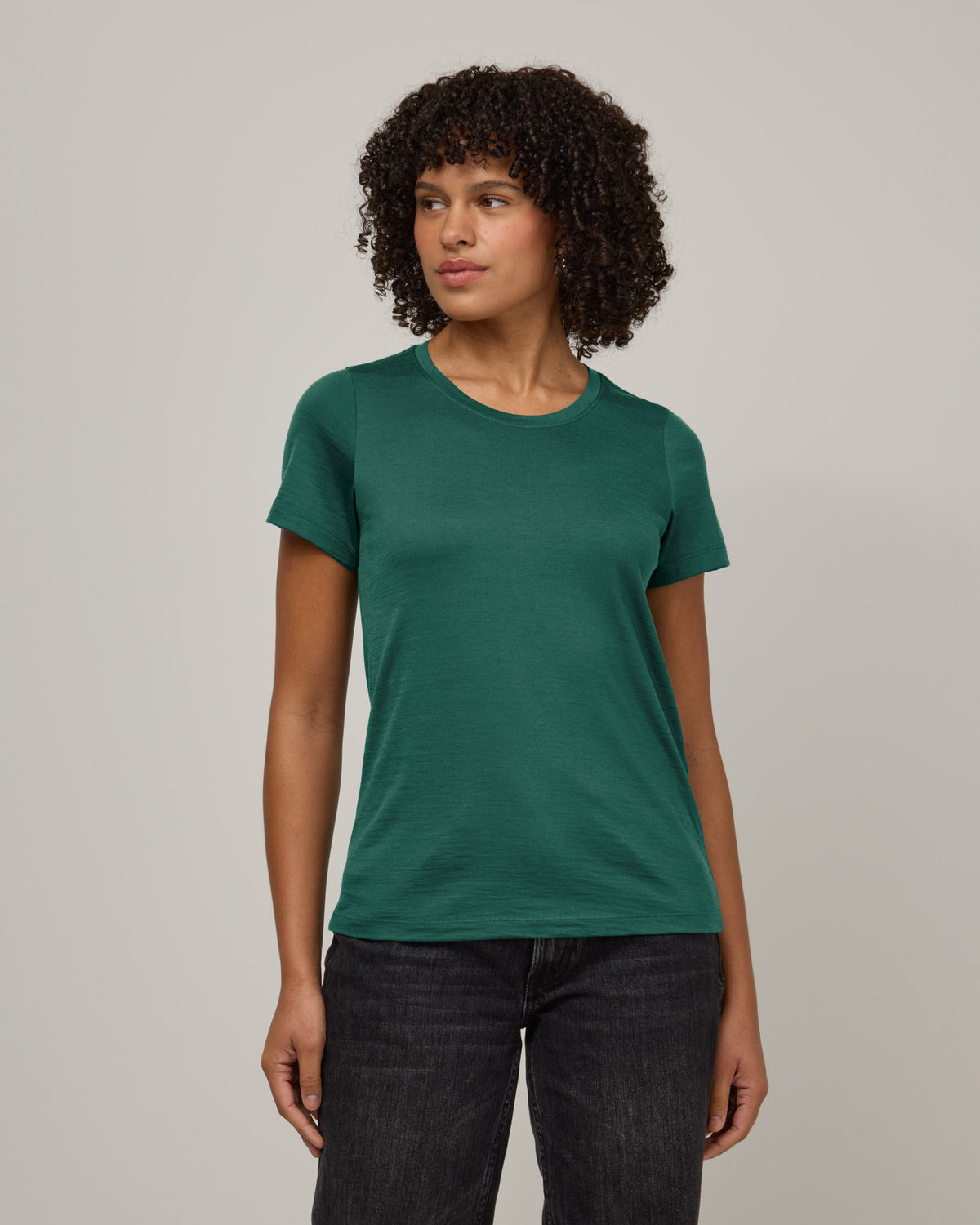 Model wearing Zoe Easy Crew Neck Tee in Emerald green. Zoe Easy Crew Neck Tee is a merino wool short sleeve, crew neck, regular fit tee available in sizes XS-3X.