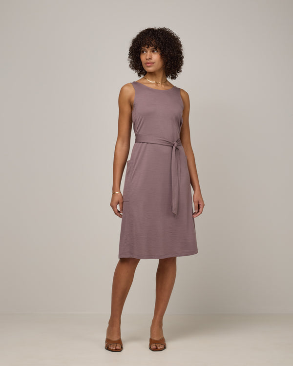 Model wearing Summer Reversible Dress in Lavender, a dusky, muted purple color. Summer Reversible Dress is a merino wool sleeveless, reversible, midi swing dress with pockets available in sizes XS-3X.