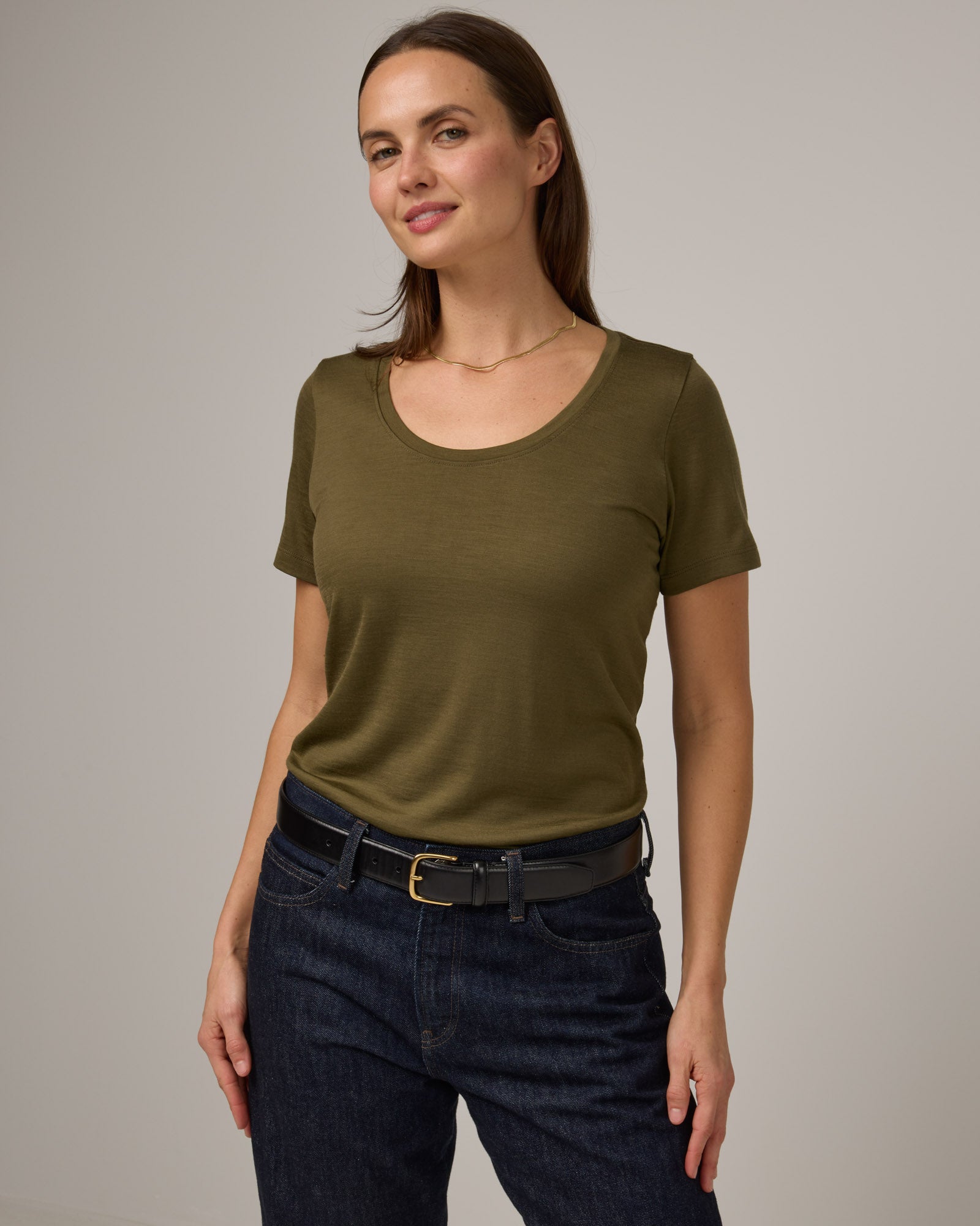 Model wearing Stella Signature Scoop Neck Tee in Olive. Stella Signature Scoop Neck Tee is a merino wool short sleeve, scoop neck, relaxed fit tee available in sizes XS-3X.