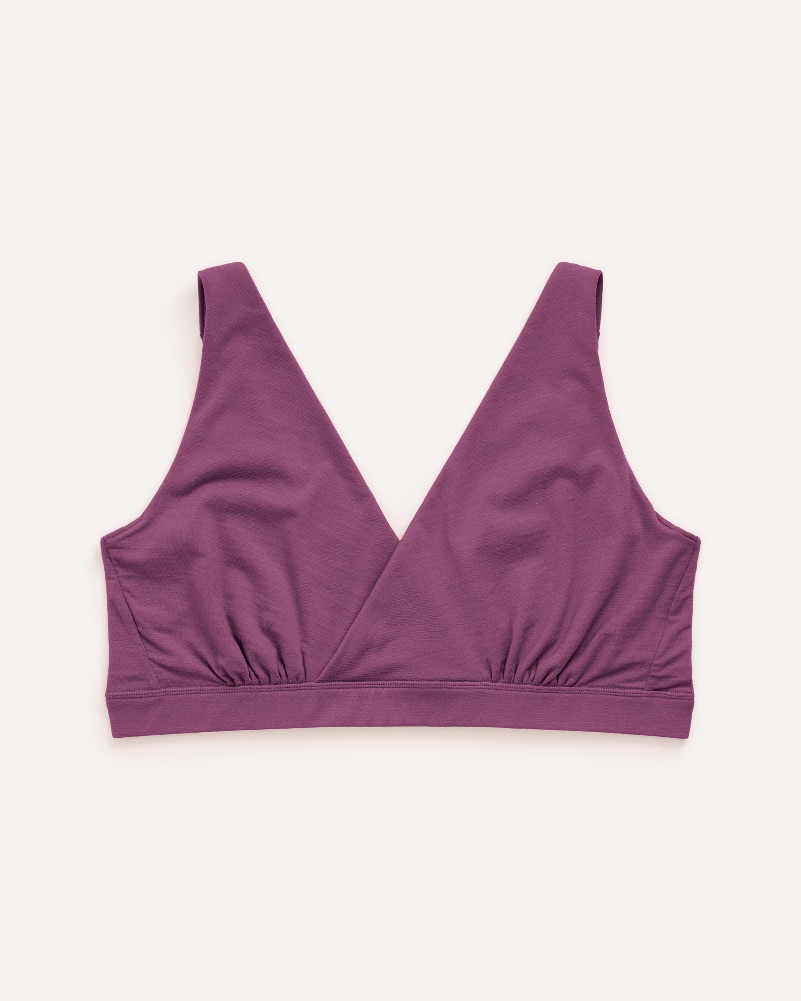 Laydown of Roam Wrap Bra in Plum, a berry pink-purple color. Roam Wrap Bra is a merino wool underwear available in sizes 1X-3X.
