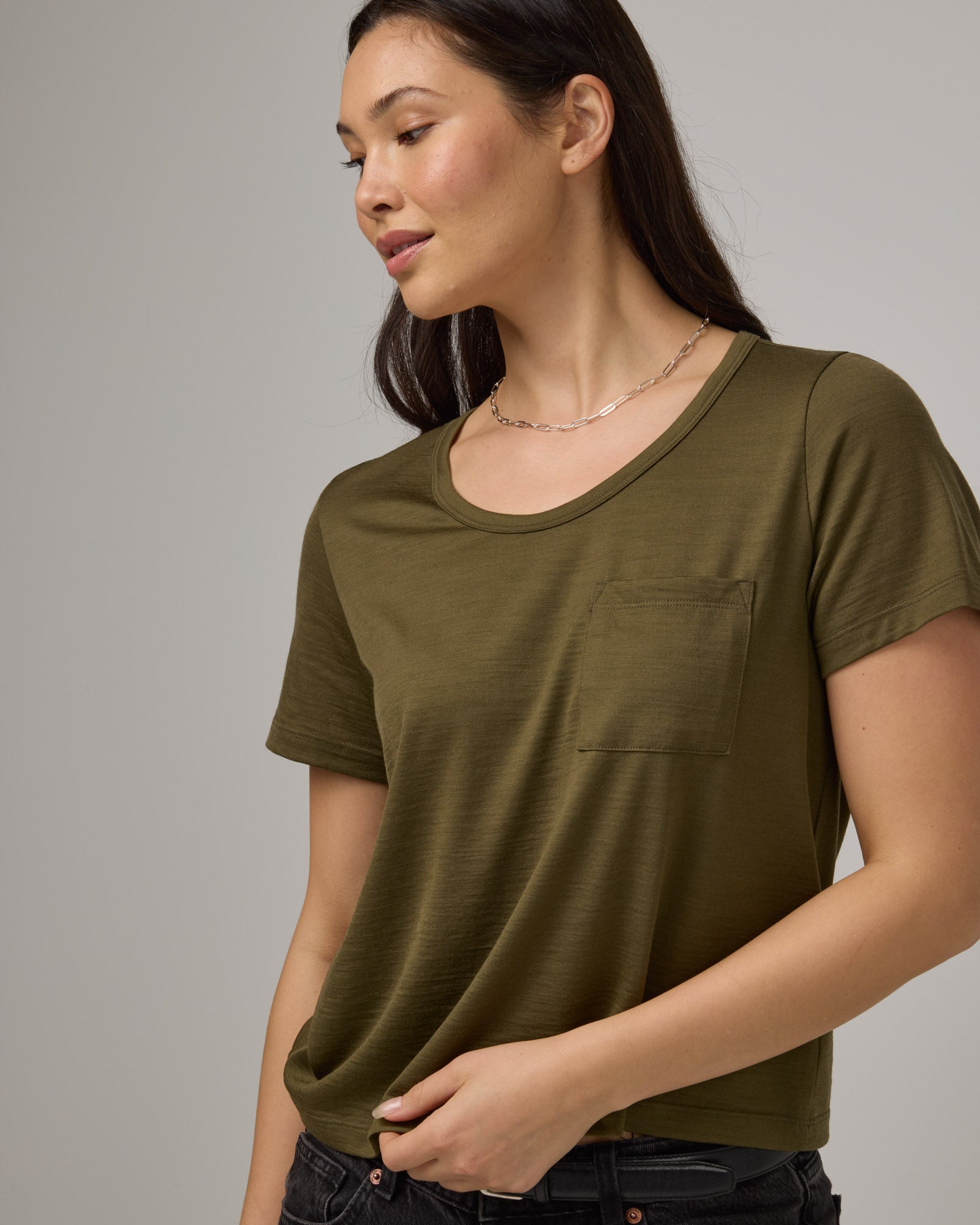 Model wearing Hailee Boxy Tee in Olive. Hailee Boxy Tee is a merino wool short sleeve, crew neck, relaxed fit tee available in sizes XS-3X.