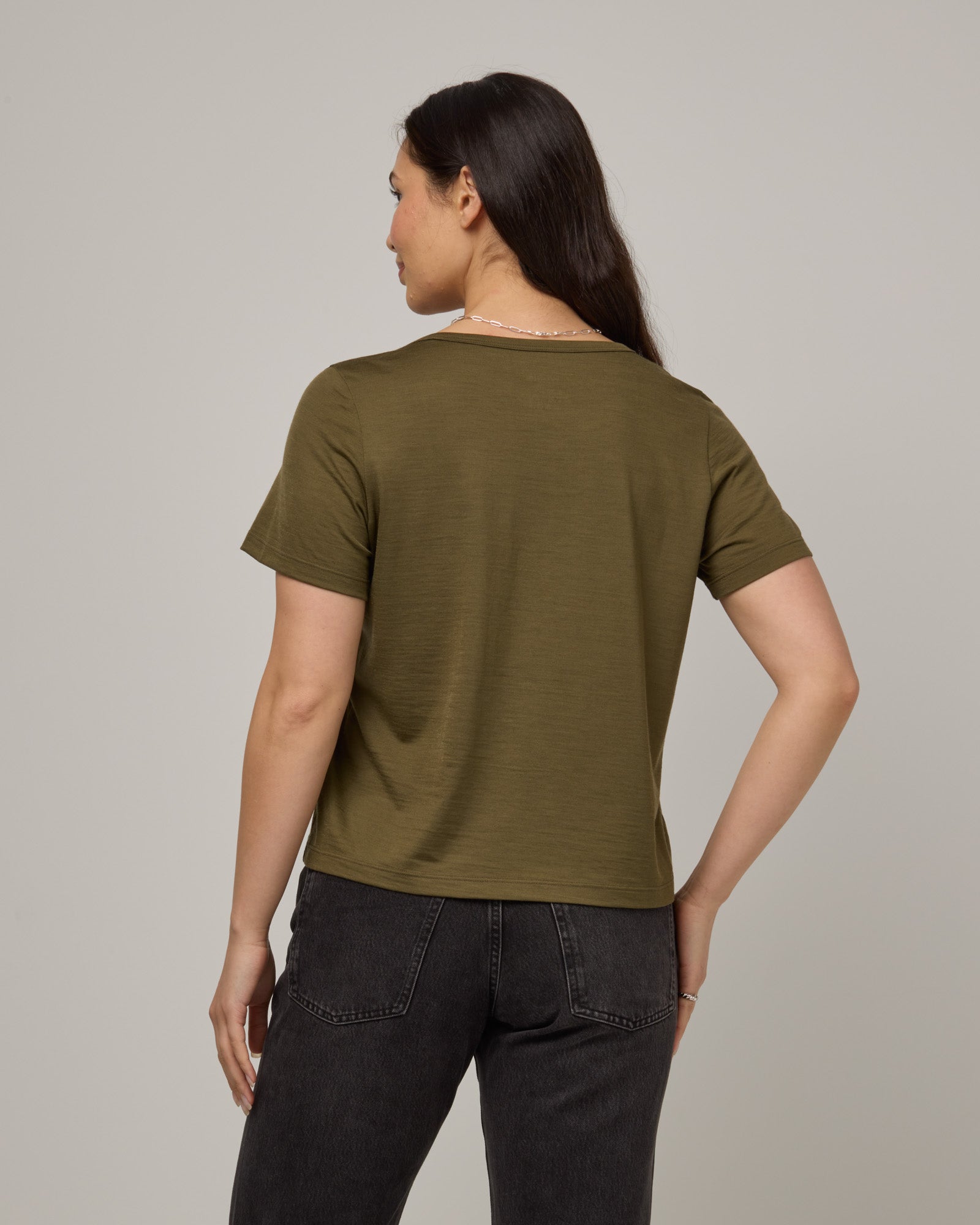 Model wearing Hailee Boxy Tee in Olive. Hailee Boxy Tee is a merino wool short sleeve, crew neck, relaxed fit tee available in sizes XS-3X.