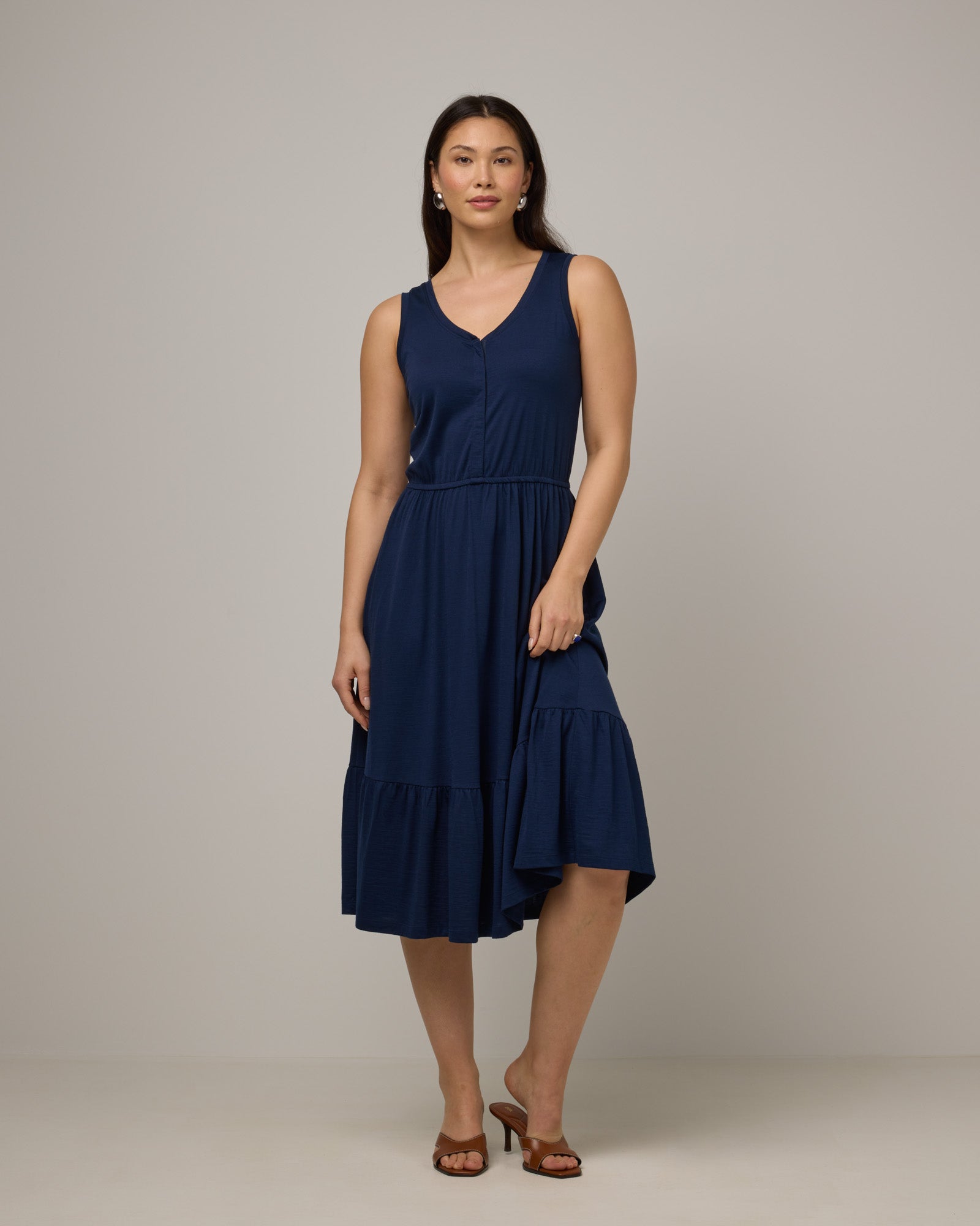 Model wearing Grace Tiered Dress in Marine Blue, a deep royal blue color. Grace Tiered Dress is a merino wool sleeveless, scoop neck, midi fit & flare dress with pockets available in sizes XS-3X.