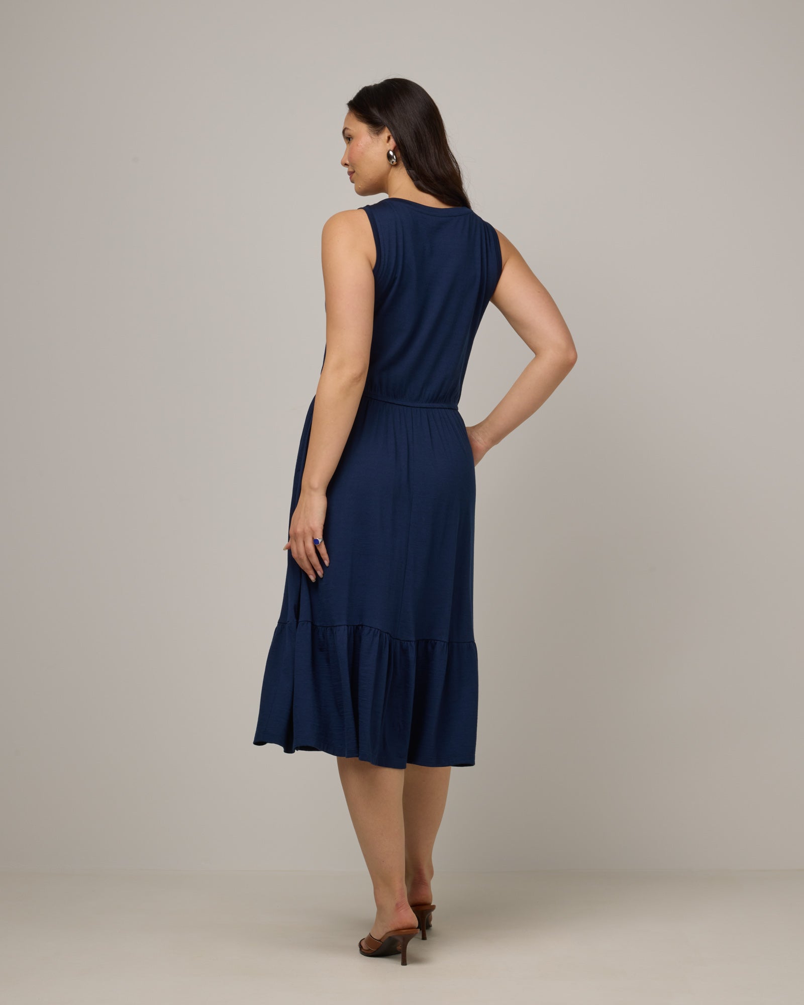 Model wearing Grace Tiered Dress in Marine Blue, a deep royal blue color. Grace Tiered Dress is a merino wool sleeveless, scoop neck, midi fit & flare dress with pockets available in sizes XS-3X.