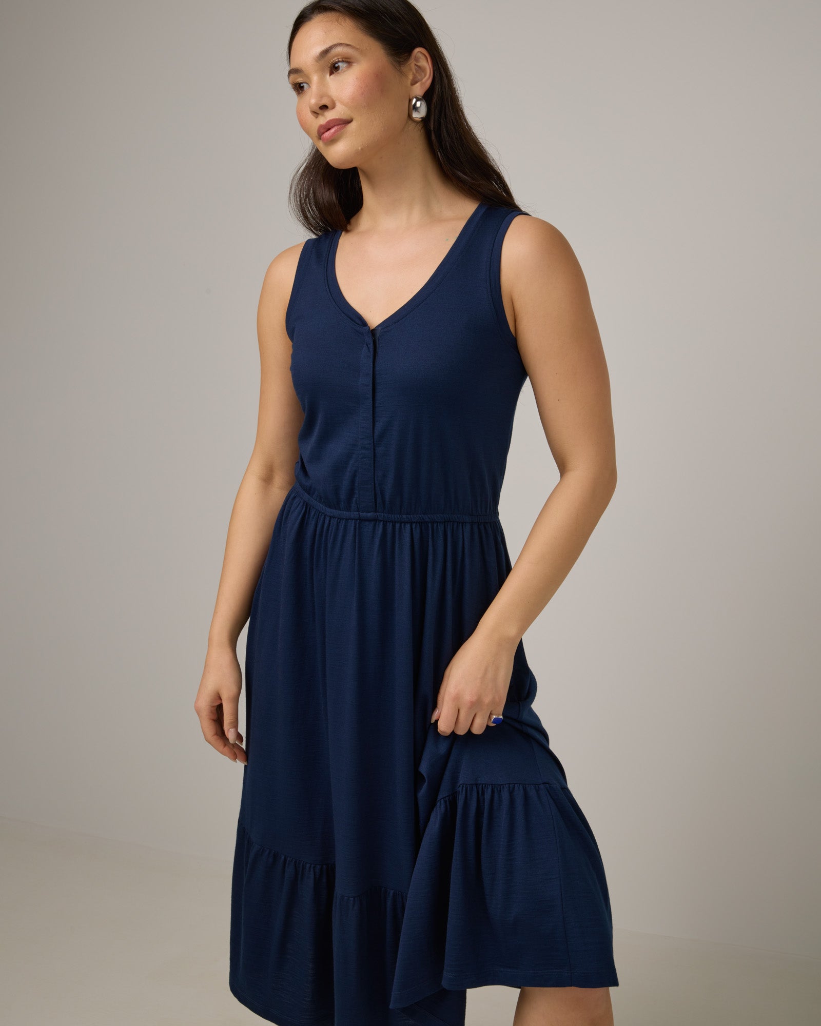 Model wearing Grace Tiered Dress in Marine Blue, a deep royal blue color. Grace Tiered Dress is a merino wool sleeveless, scoop neck, midi fit & flare dress with pockets available in sizes XS-3X.