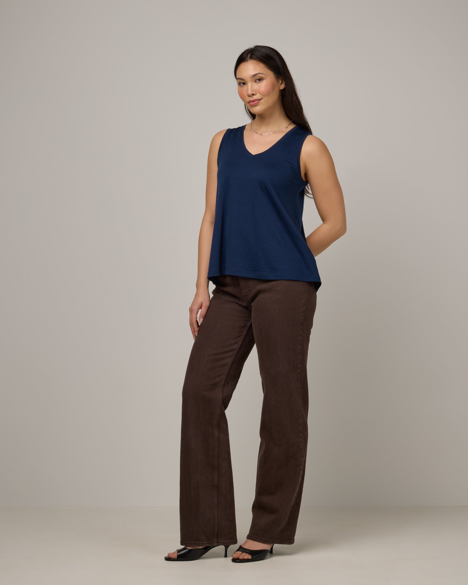 Model wearing Poppy Signature Reversible Tank in Marine Blue, a deep royal blue color. Poppy Signature Reversible Tank is a merino wool sleeveless, reversible, relaxed fit top available in sizes XS-3X.