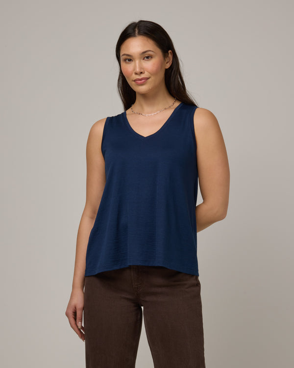 Model wearing Poppy Signature Reversible Tank in Marine Blue, a deep royal blue color. Poppy Signature Reversible Tank is a merino wool sleeveless, reversible, relaxed fit top available in sizes XS-3X.