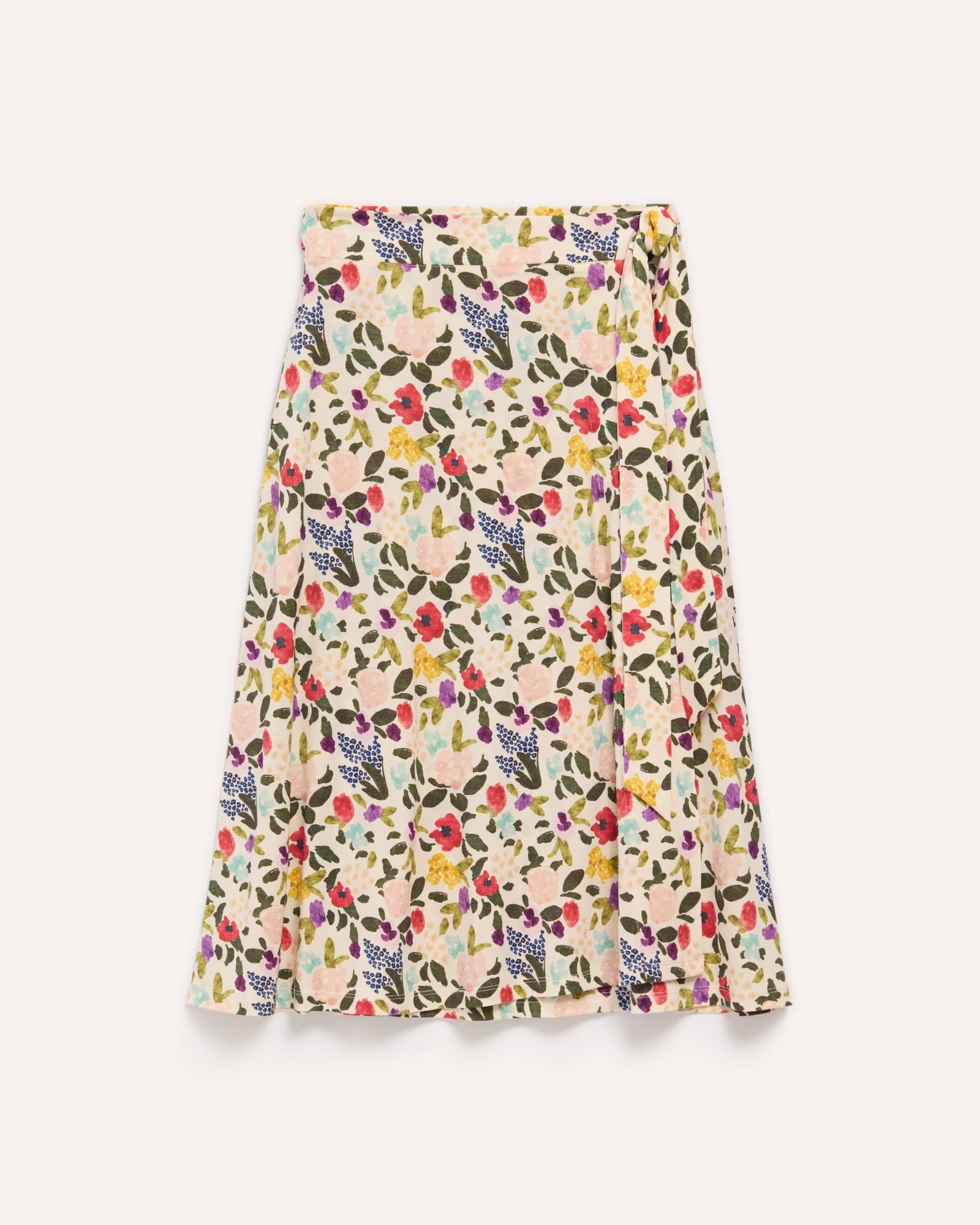 Laydown of Skye Wrap Skirt in Watercolor Floral, a multi-colored floral print on a cream background. Skye Wrap Skirt is a merino wool skirt with pockets available in sizes XS-3X.