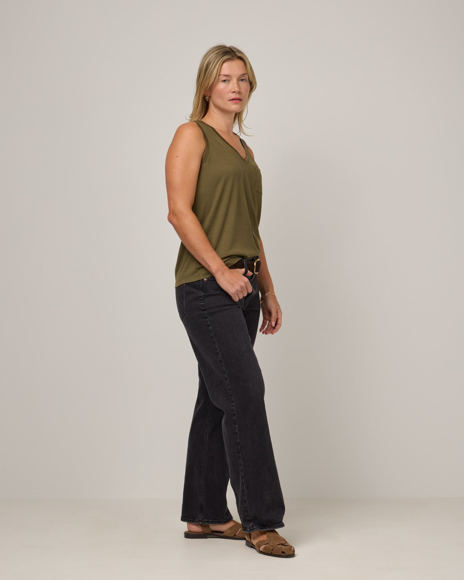 Model wearing Penelope Pocket Tank in Olive. Penelope Pocket Tank is a merino wool sleeveless, v-neck tank with a pocket available in sizes XS-3X.