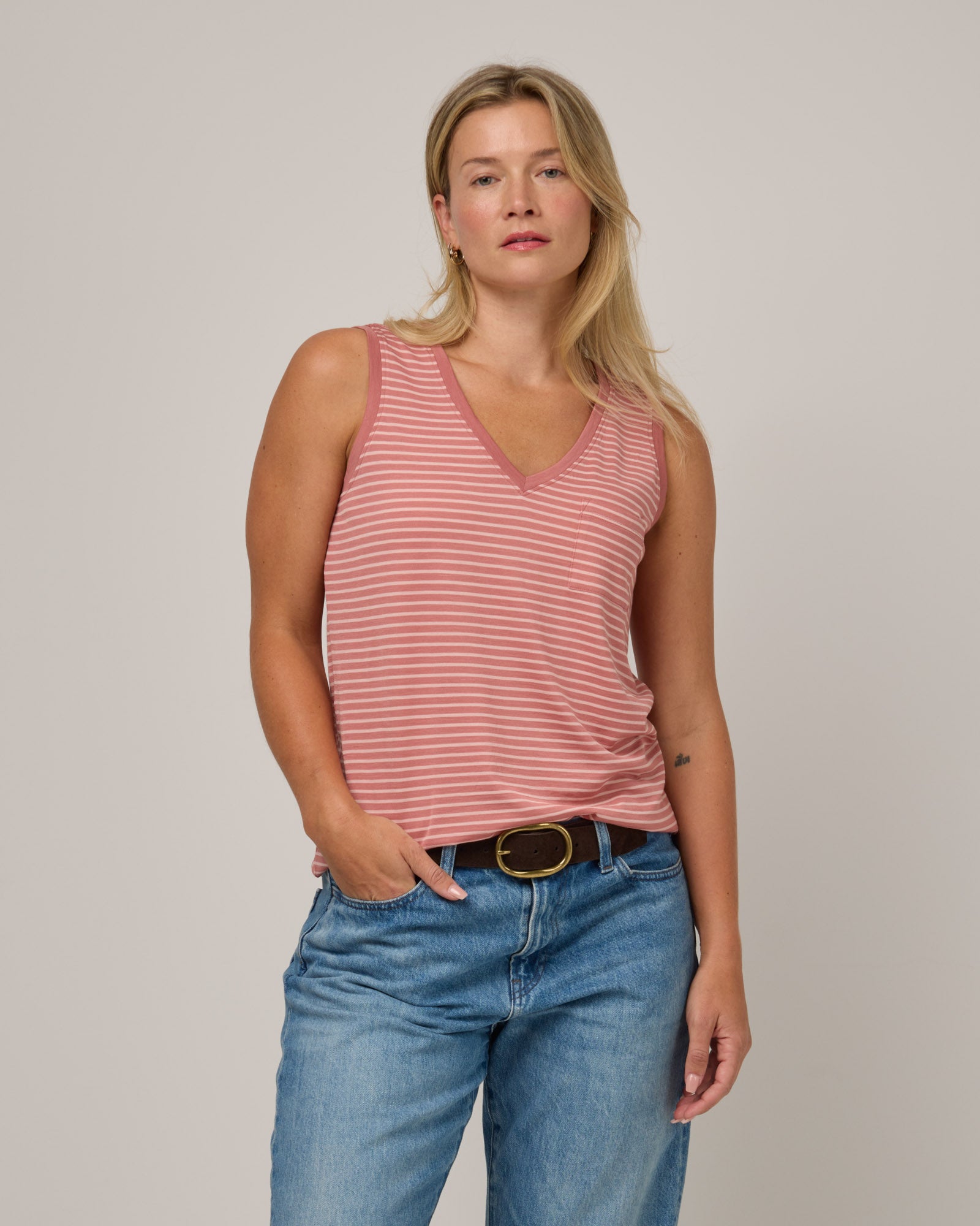 Model wearing Penelope Pocket Tank in Vintage Rose & Blush Pink Stripe. Penelope Pocket Tank is a merino wool sleeveless, v-neck tank with a pocket available in sizes XS-3X.