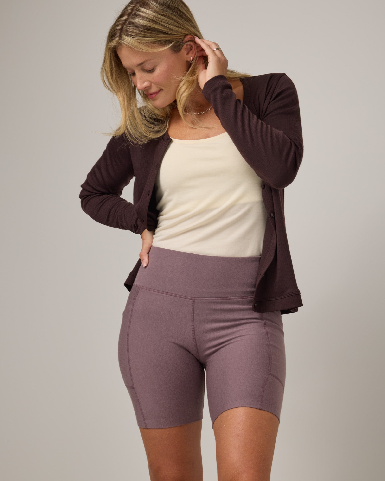 Model wearing Summit Pocket Bike Short in Lavender, a dusky muted purple color. Summit Pocket Bike Short is a merino wool short with pockets available in sizes XS-3X.