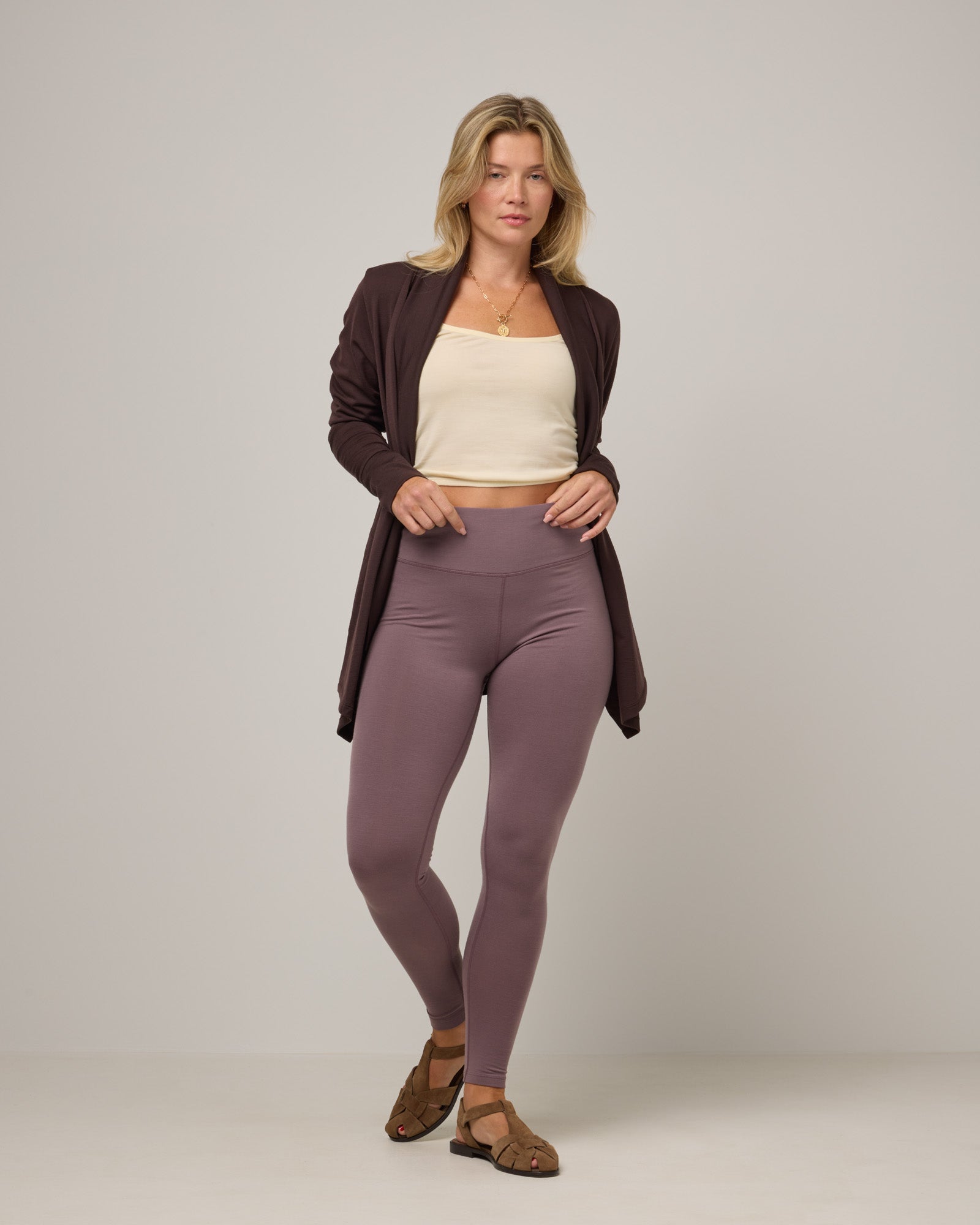 Model wearing Summit Legging in Lavender, a dusky muted purple color. Summit Legging is a merino wool legging available in sizes XS-3X.