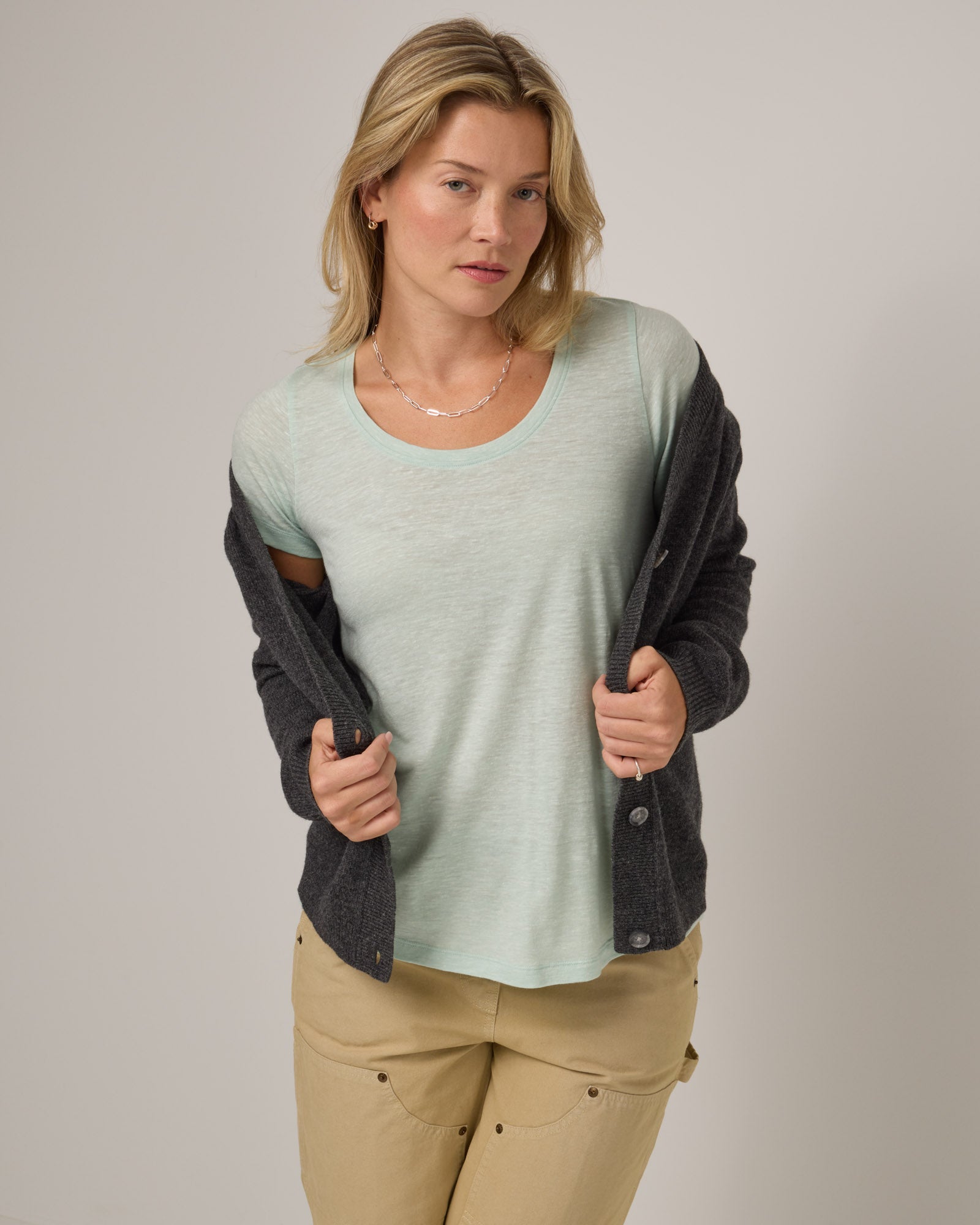 Model wearing Stella Linen Scoop Neck Tee in Morning Dew, a bright mint green color. Stella Linen Scoop Neck Tee is a merino wool short sleeve, scoop neck, relaxed fit tee available in sizes XS-3X.