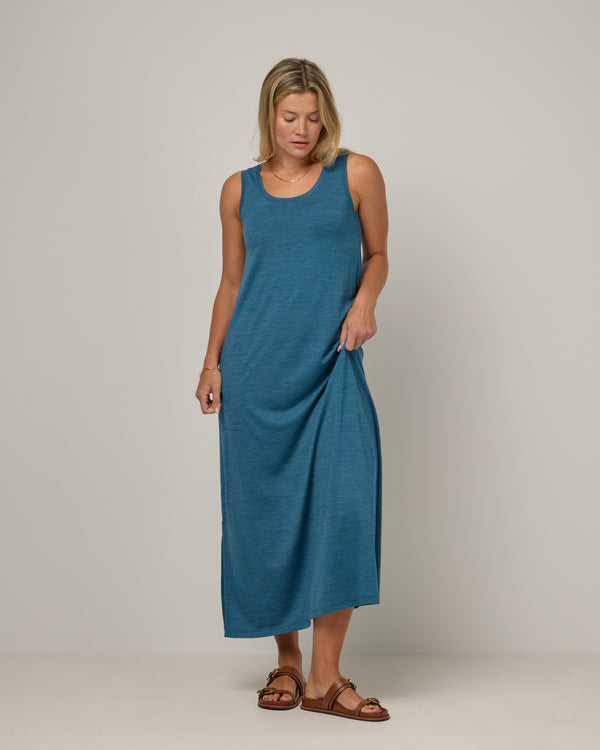 Model wearing Audrey TENCEL™ Maxi Dress in Ocean Teal Heather, a medium blue-green color. Audrey TENCEL™ Maxi Dress is a merino wool sleeveless, scoop neck, maxi shift dress with pockets available in sizes XS-3X.
