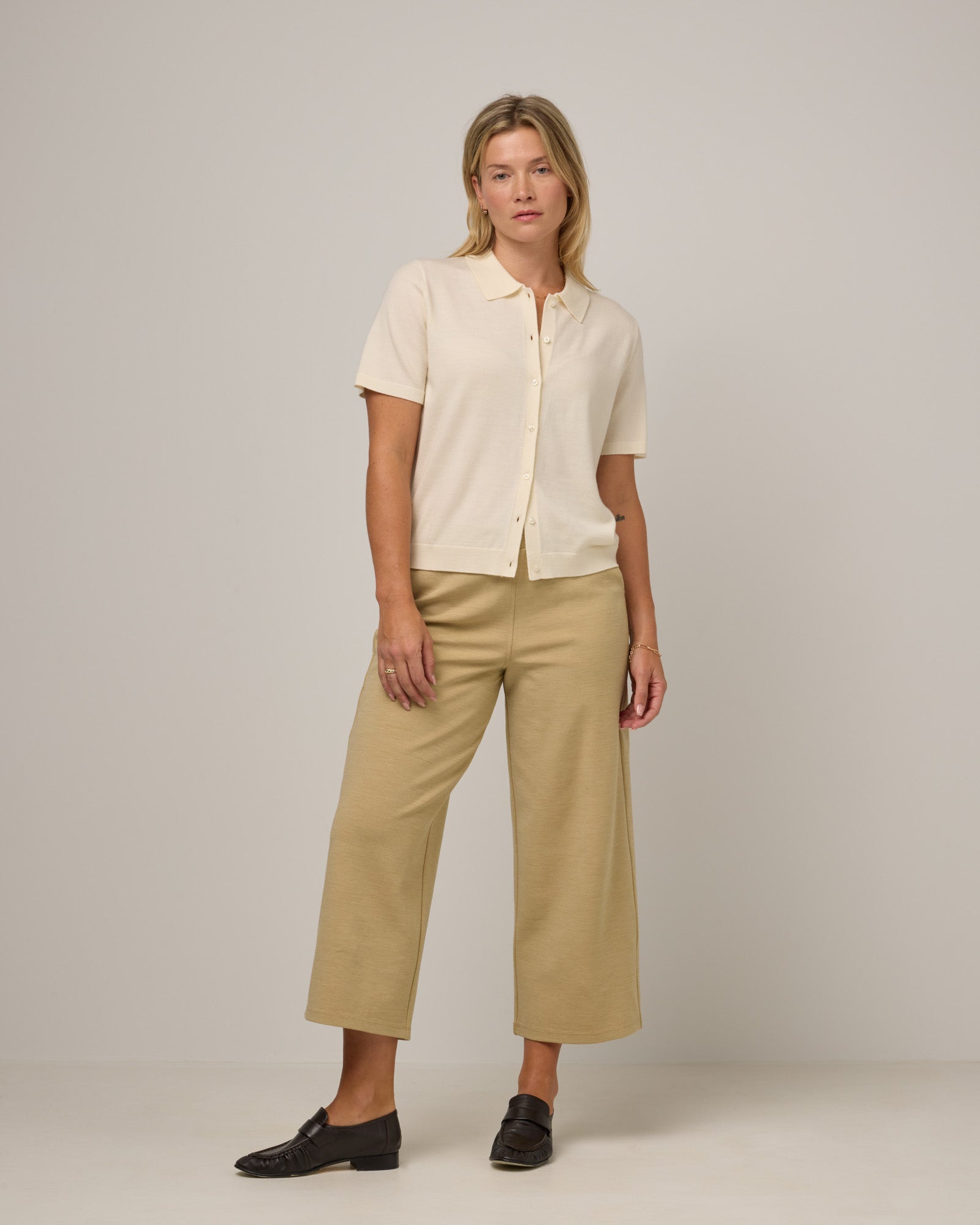 Model wearing Frame Ponte Culotte in Sahara, a warm, sandy tan neutral color. Frame Ponte Culotte is a merino wool pant with pockets available in sizes XS-3X Regular, XS-XL Petite.