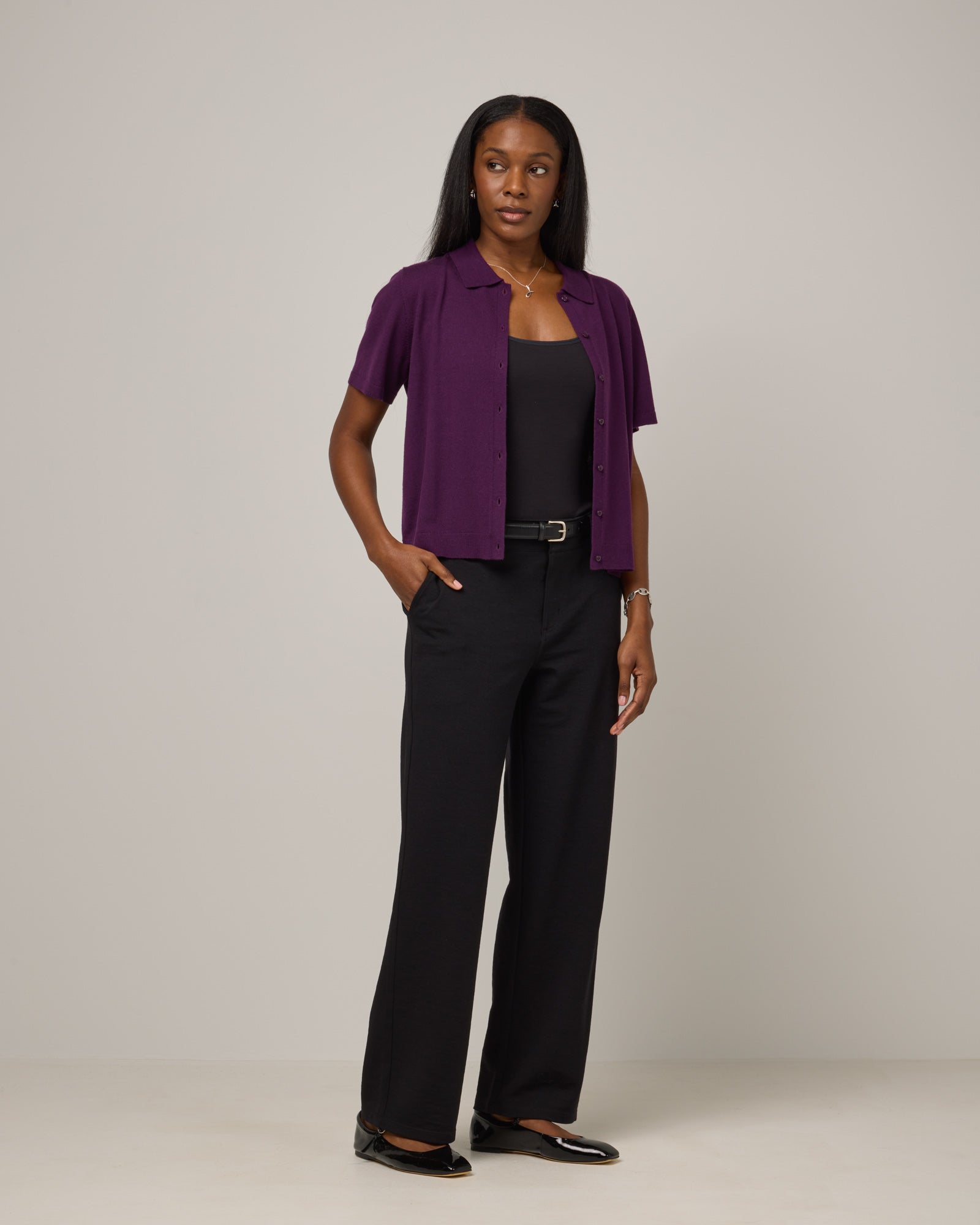 Model wearing Harper Collared Sweater in Marionberry, a dark berry purple color. Harper Collared Sweater is a merino wool short sleeve, collared, sweater available in sizes XS-XXL.