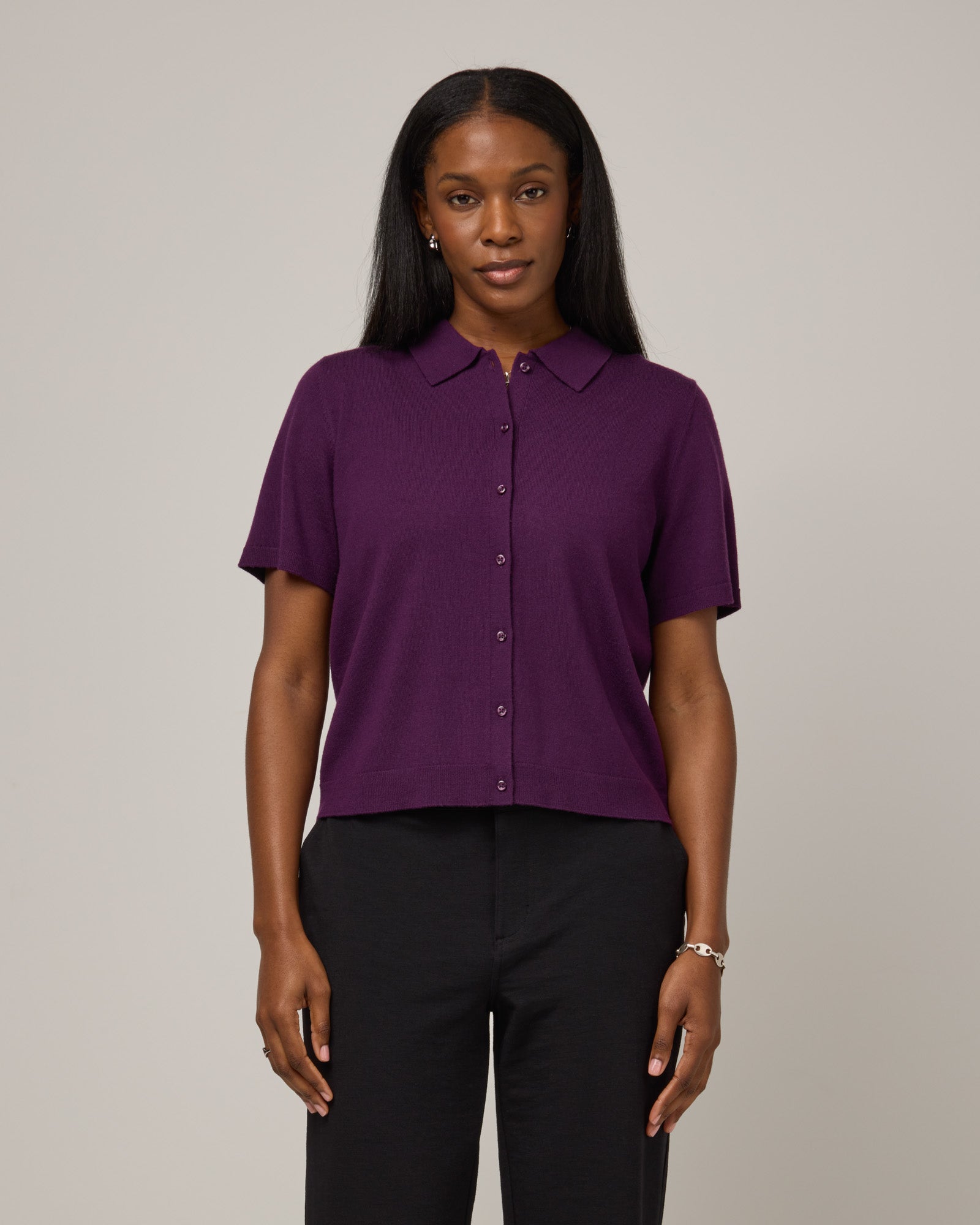 Model wearing Harper Collared Sweater in Marionberry, a dark berry purple color. Harper Collared Sweater is a merino wool short sleeve, collared, sweater available in sizes XS-XXL.