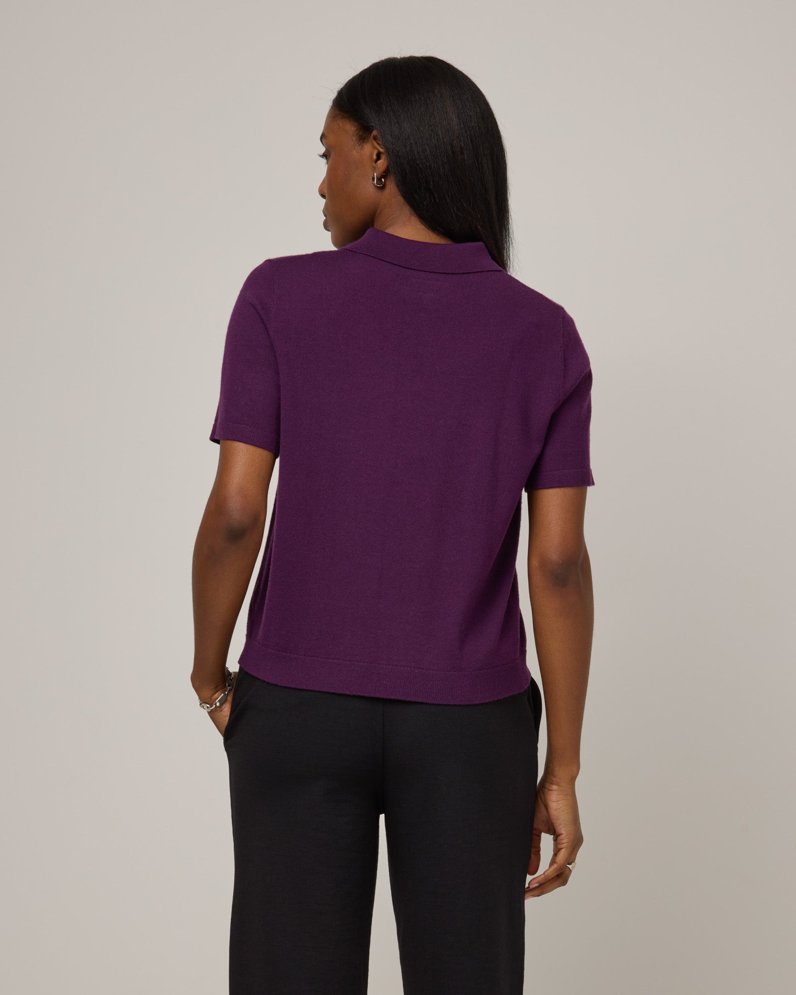 Model wearing Harper Collared Sweater in Marionberry, a dark berry purple color. Harper Collared Sweater is a merino wool short sleeve, collared, sweater available in sizes XS-XXL.