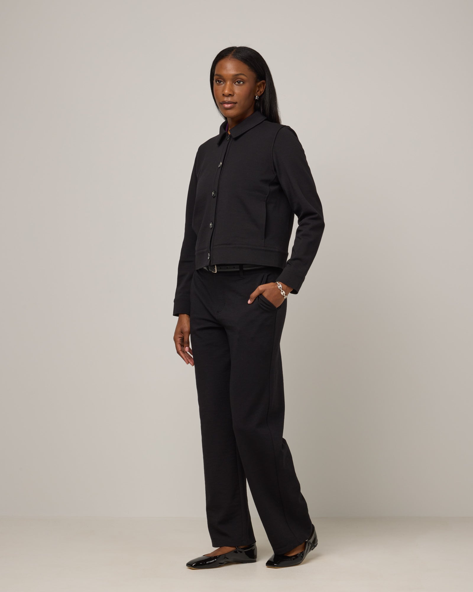 Model wearing Carson Ponte Trouser in Black. Carson Ponte Trouser is a merino wool pant with pockets available in sizes XS-3X Regular, XS-XL Petite.