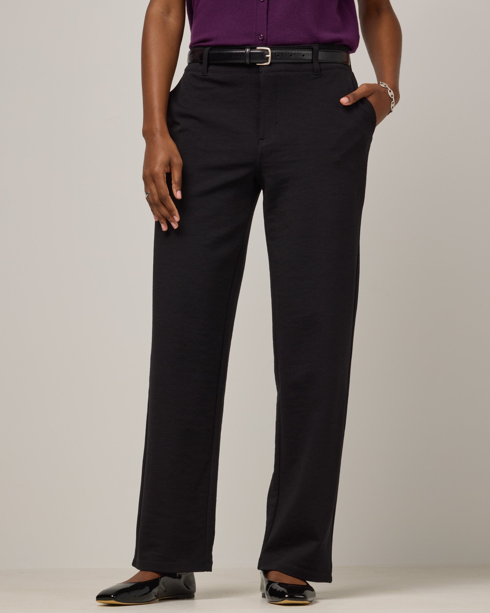Model wearing Carson Ponte Trouser in Black. Carson Ponte Trouser is a merino wool pant with pockets available in sizes XS-3X Regular, XS-XL Petite.