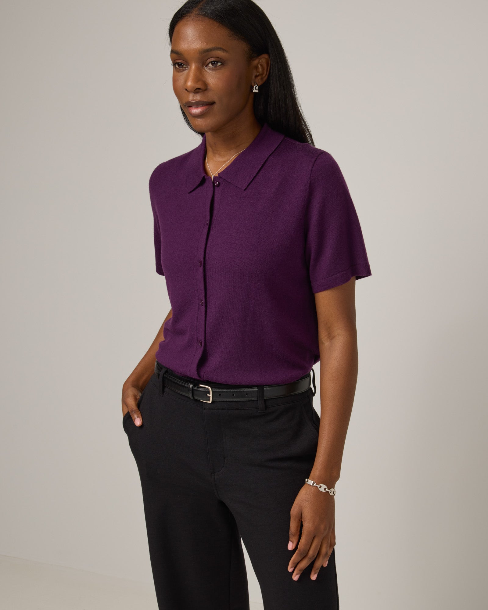 Model wearing Harper Collared Sweater in Marionberry, a dark berry purple color. Harper Collared Sweater is a merino wool short sleeve, collared, sweater available in sizes XS-XXL.