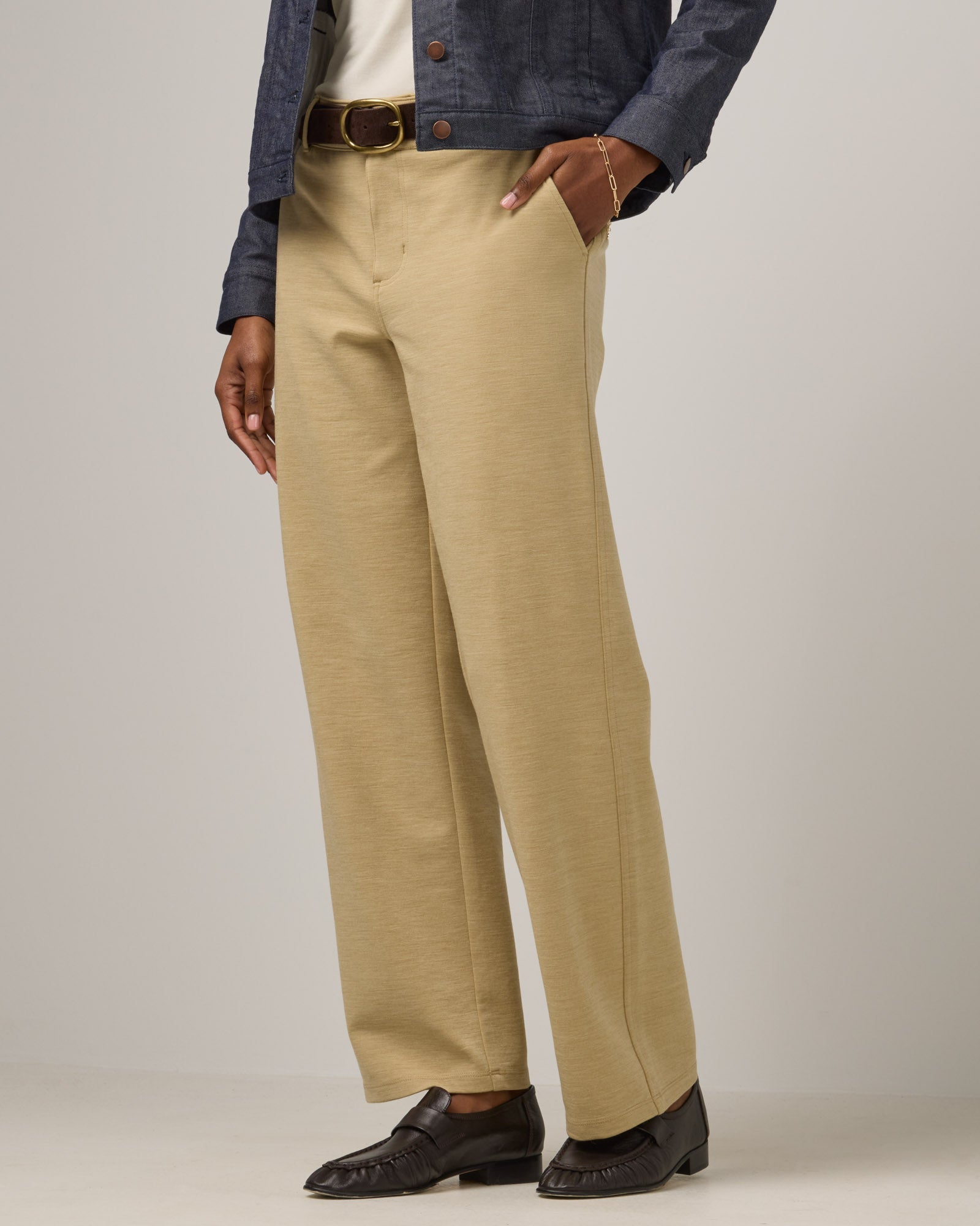 Model wearing Carson Ponte Trouser in Sahara, a warm, sandy tan neutral color. Carson Ponte Trouser is a merino wool pant with pockets available in sizes XS-3X Regular, XS-XL Petite.