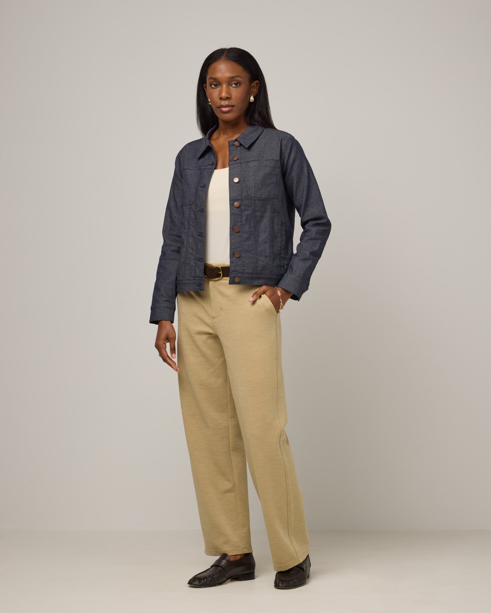 Model wearing Carson Ponte Trouser in Sahara, a warm, sandy tan neutral color. Carson Ponte Trouser is a merino wool pant with pockets available in sizes XS-3X Regular, XS-XL Petite.