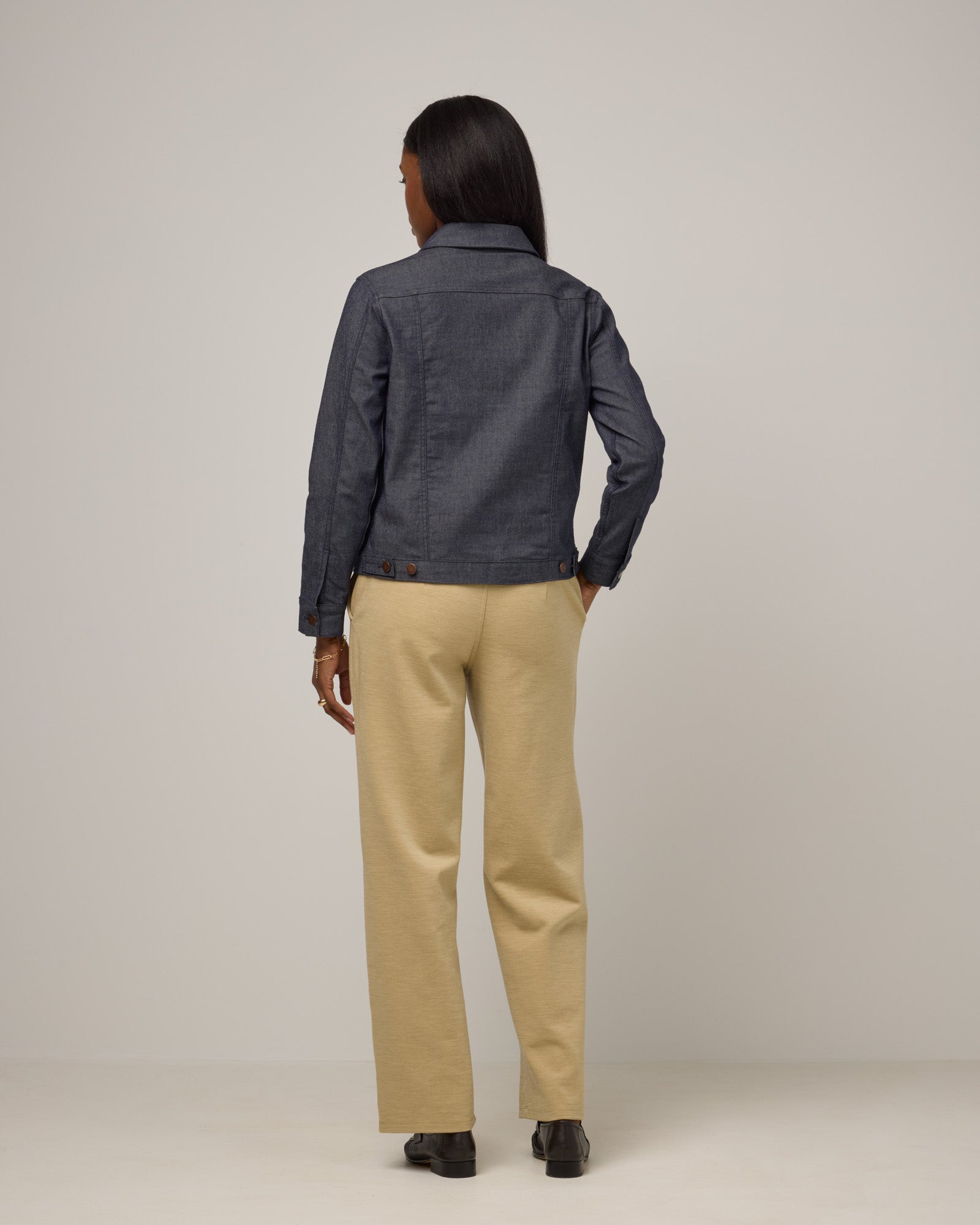 Model wearing Carson Ponte Trouser in Sahara, a warm, sandy tan neutral color. Carson Ponte Trouser is a merino wool pant with pockets available in sizes XS-3X Regular, XS-XL Petite.