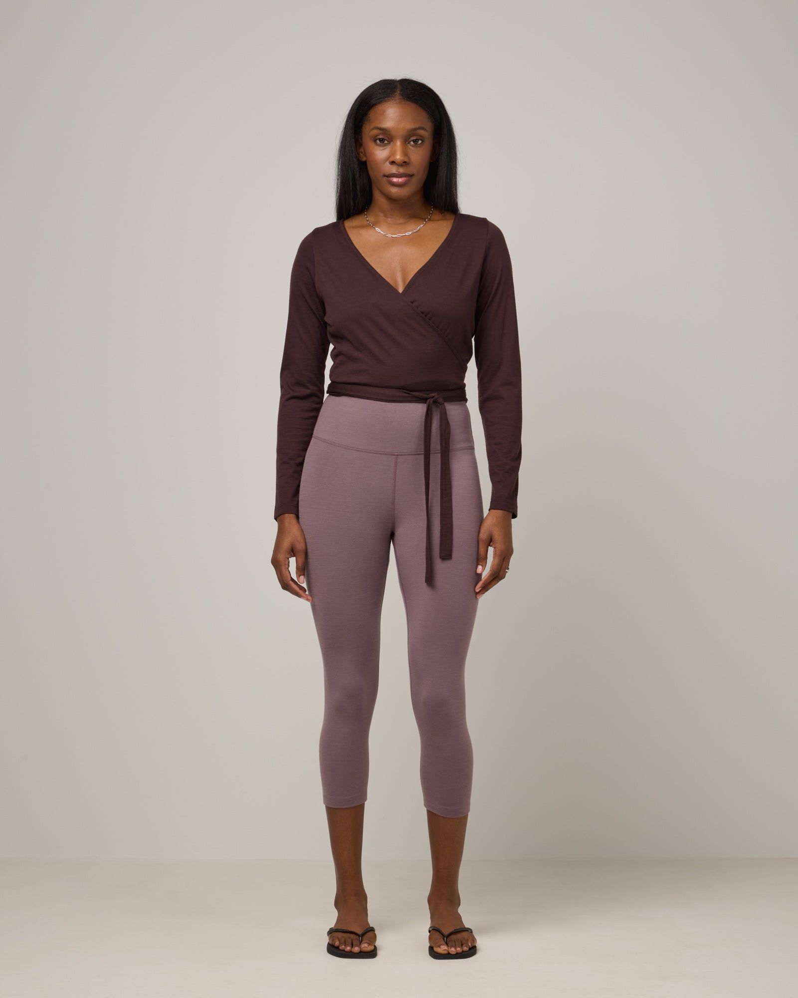 Model wearing Summit Crop Legging in Lavender, a dusky muted purple color. Summit Crop Legging is a merino wool legging available in sizes XS-3X.